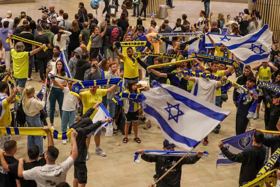 Israeli soccer fans are relieved after arriving back from Holland background