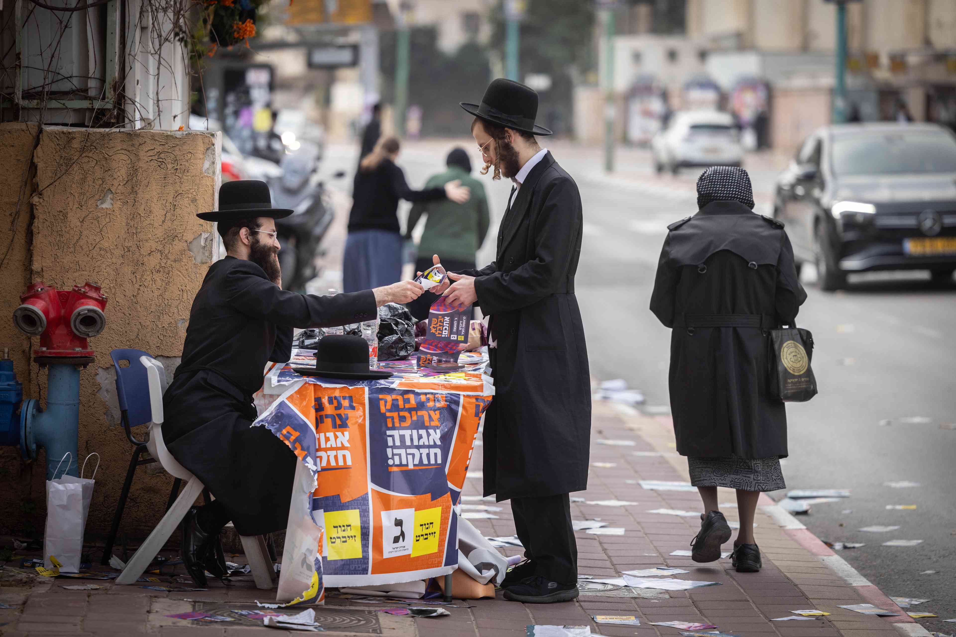Ultra orthodox jews walking in the street in the Ultra orthodox town of Bnei Brak background