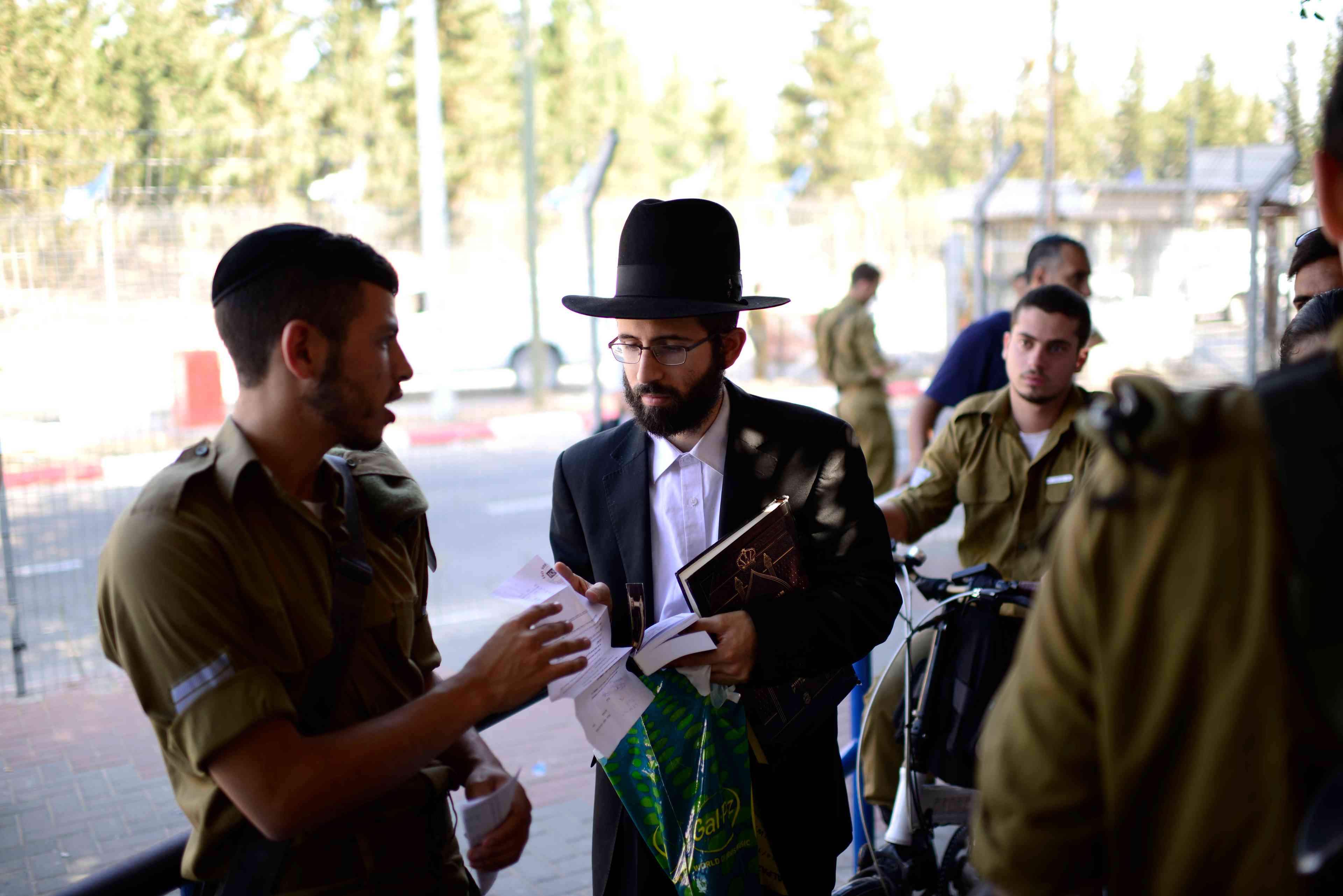 Young Israelis arrive to the Tel HaShomer millitary base to enlist to the "Netzah Yehuda" battalion background