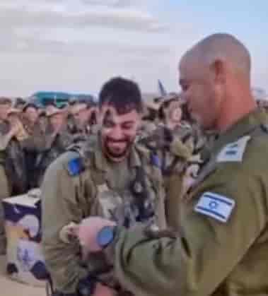 Lt. Col. Tal Iglitzki gives his son his beret background