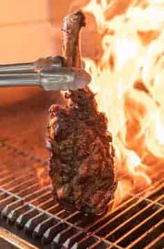 Steak on the grill at Caballero, Jerusalem background