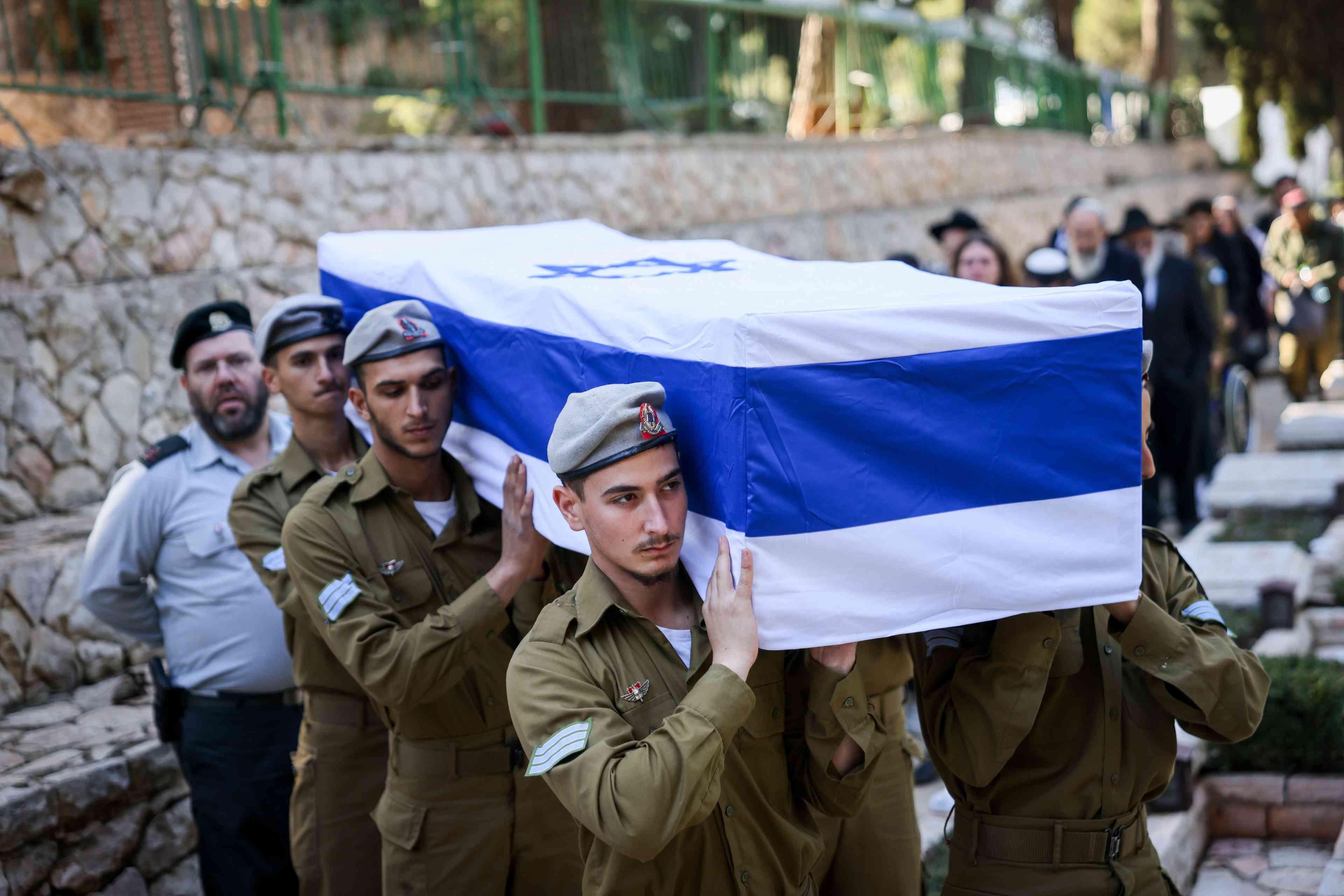 Family and friends of IDF soldier Staff sergeant Zamir Burke attend his funeral at Mount Herzl Military Cemetery in Jerusalem on December 1, 2024. background