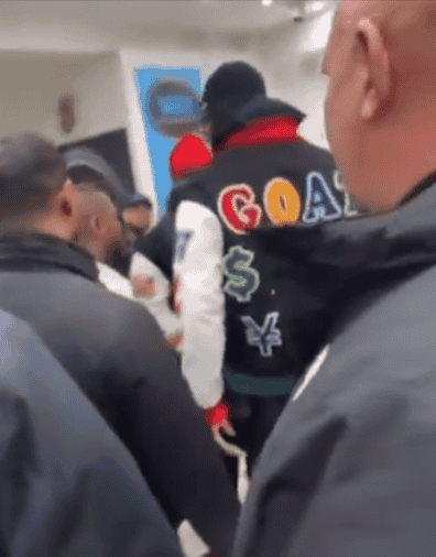 Mayweather surrounded in a shop background