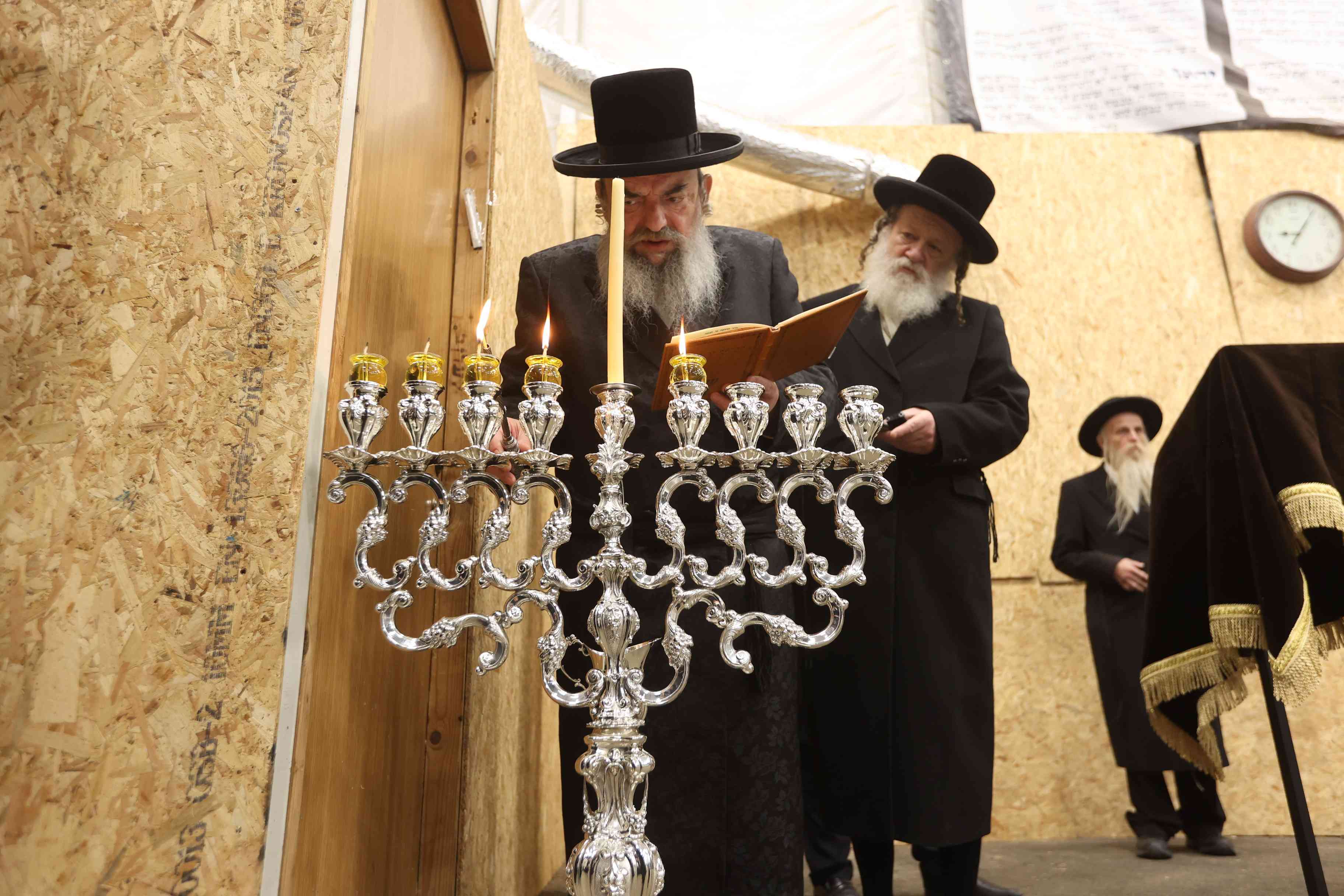 Grand Rabbi of Lelov and his followers attend a Hanukkah ceremony in Beit Shemesh, on December 29, 2024.  background