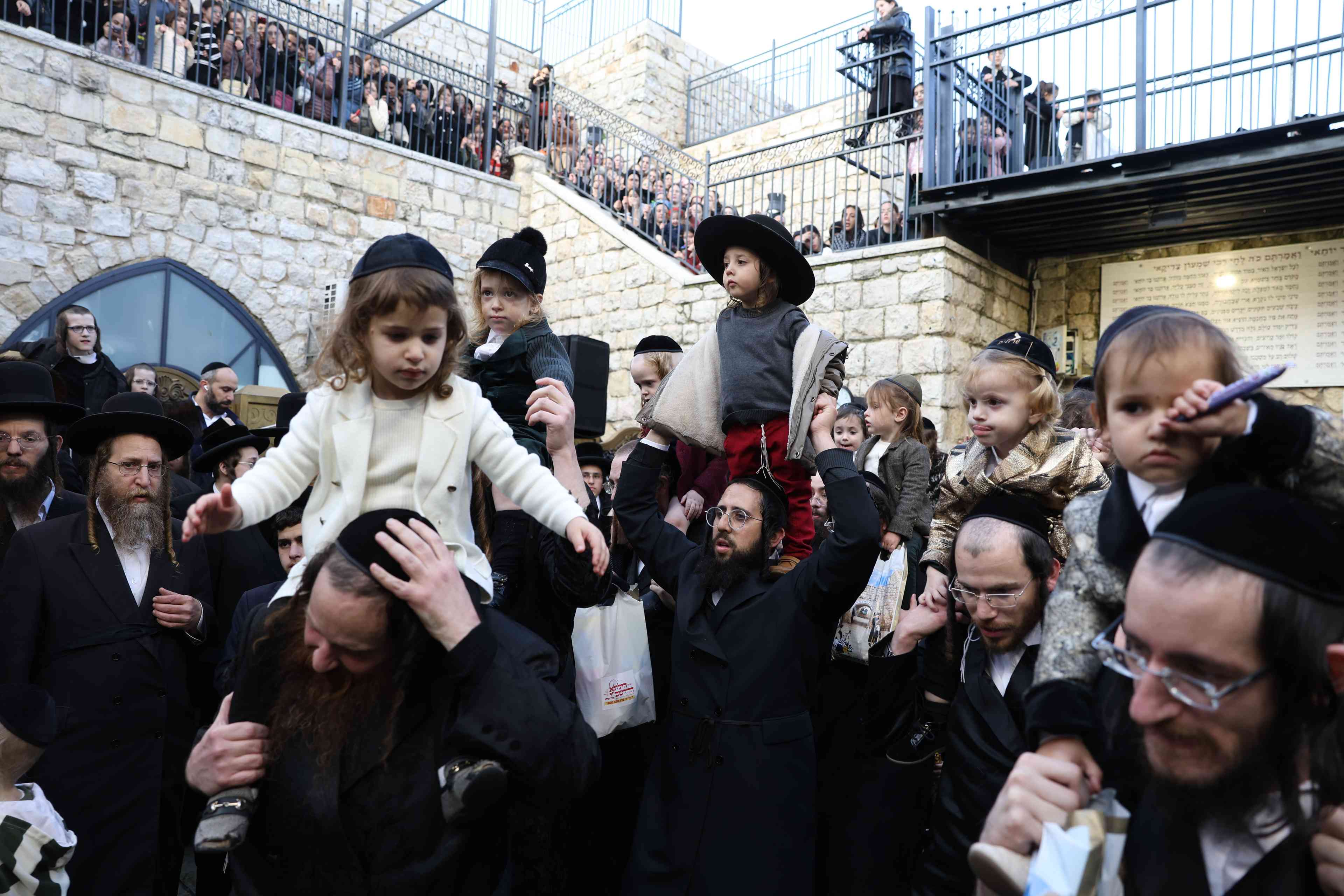 Jewish men dance during a special celebration marking the end of the jewish holiday of Hanukkah, at the Rashbi gravesite in Meron, Northern Israel, on January 2, 2025 background