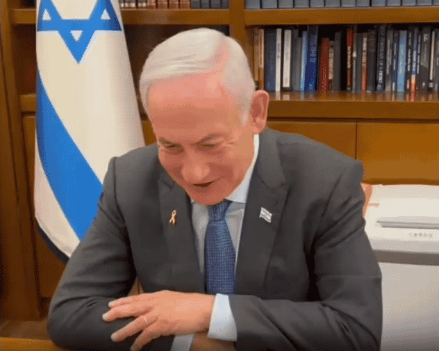 Prime Minister Benjamin Netanyahu talking to the parents of the three hostages. background