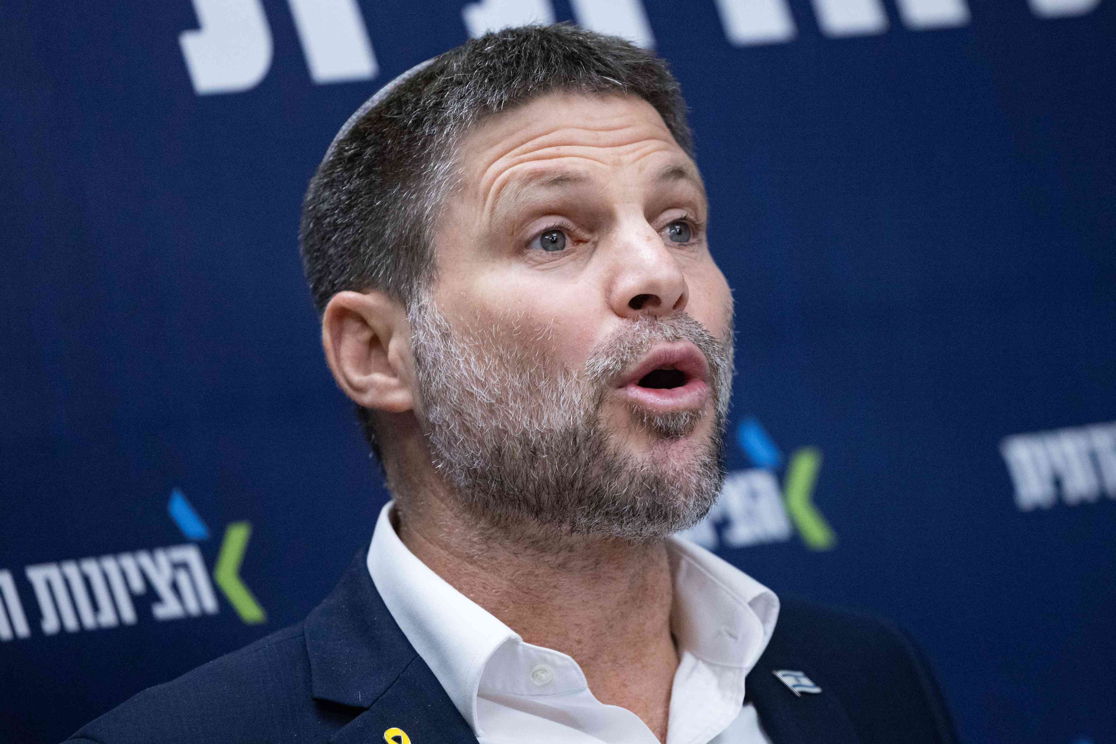Finance Minister Bezalel Smotrich. background