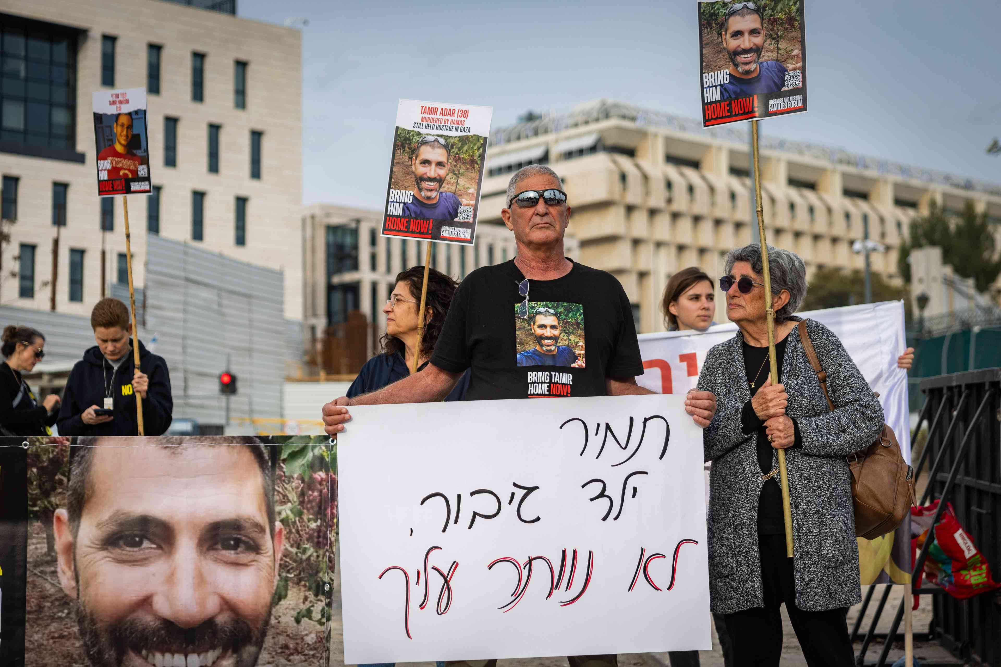 Released hostage Adina Moshe, Family members of Israelis held hostage in the Gaza Strip and activists protest for the release of all the hostages in Gaza, outside the Prime Minister's office in Jerusalem, February 3, 2025 background
