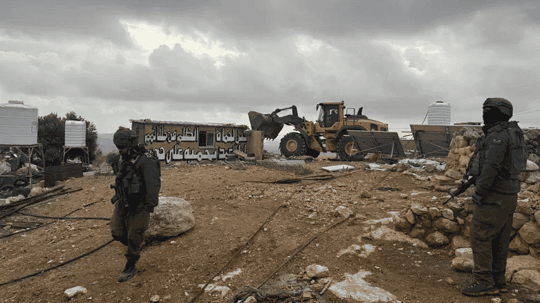 Demolition in Hebron hills background