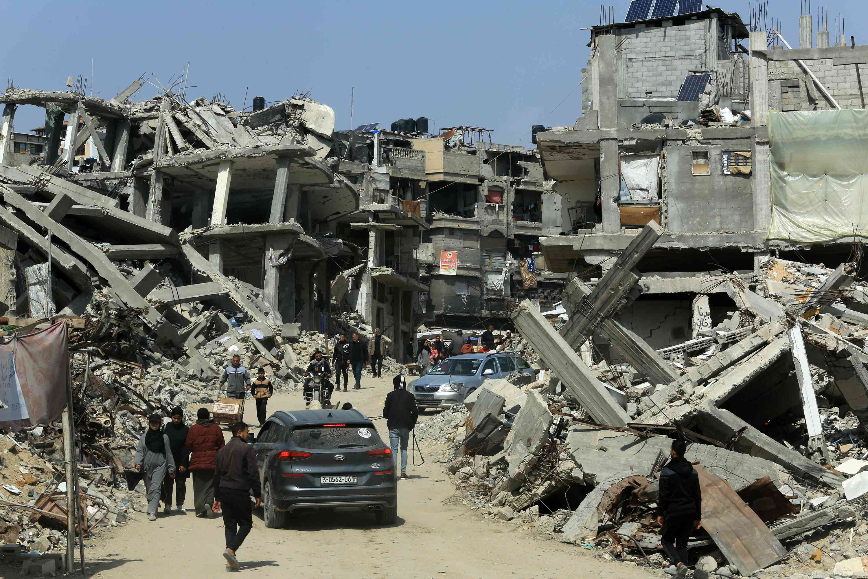 Palestinians live among the rubble of their homes which were destroyed in the war between Israel and Hamas, in the city of Khan Yunis, southern Gaza Strip background