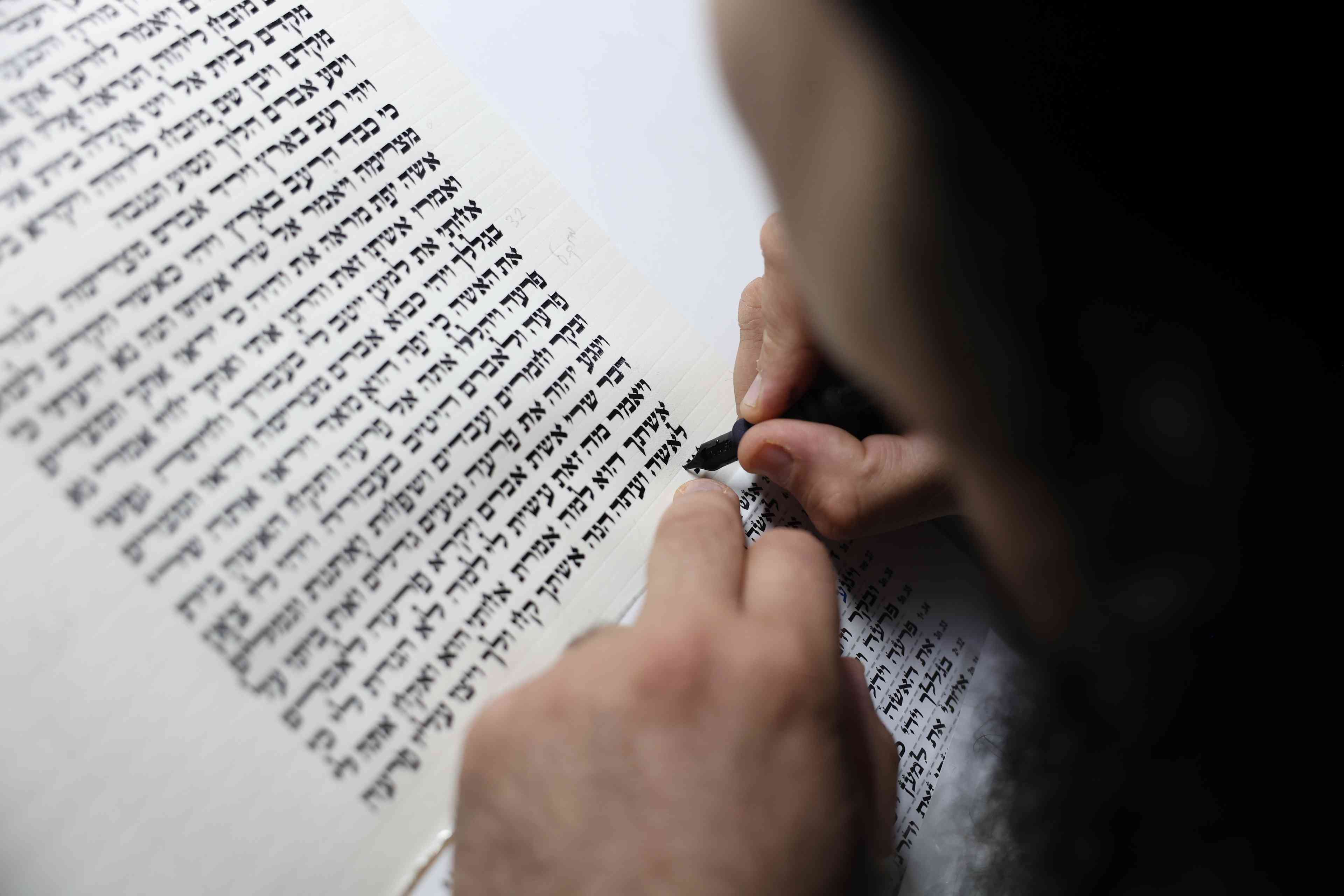 Nadav Elhadad, a Sefer Torah scribe, sofer stam, from the "Har Sinai" foundation, seen scribing a new Torah scroll in the Northern Israeli town of Tzfat. February 10, 2025.