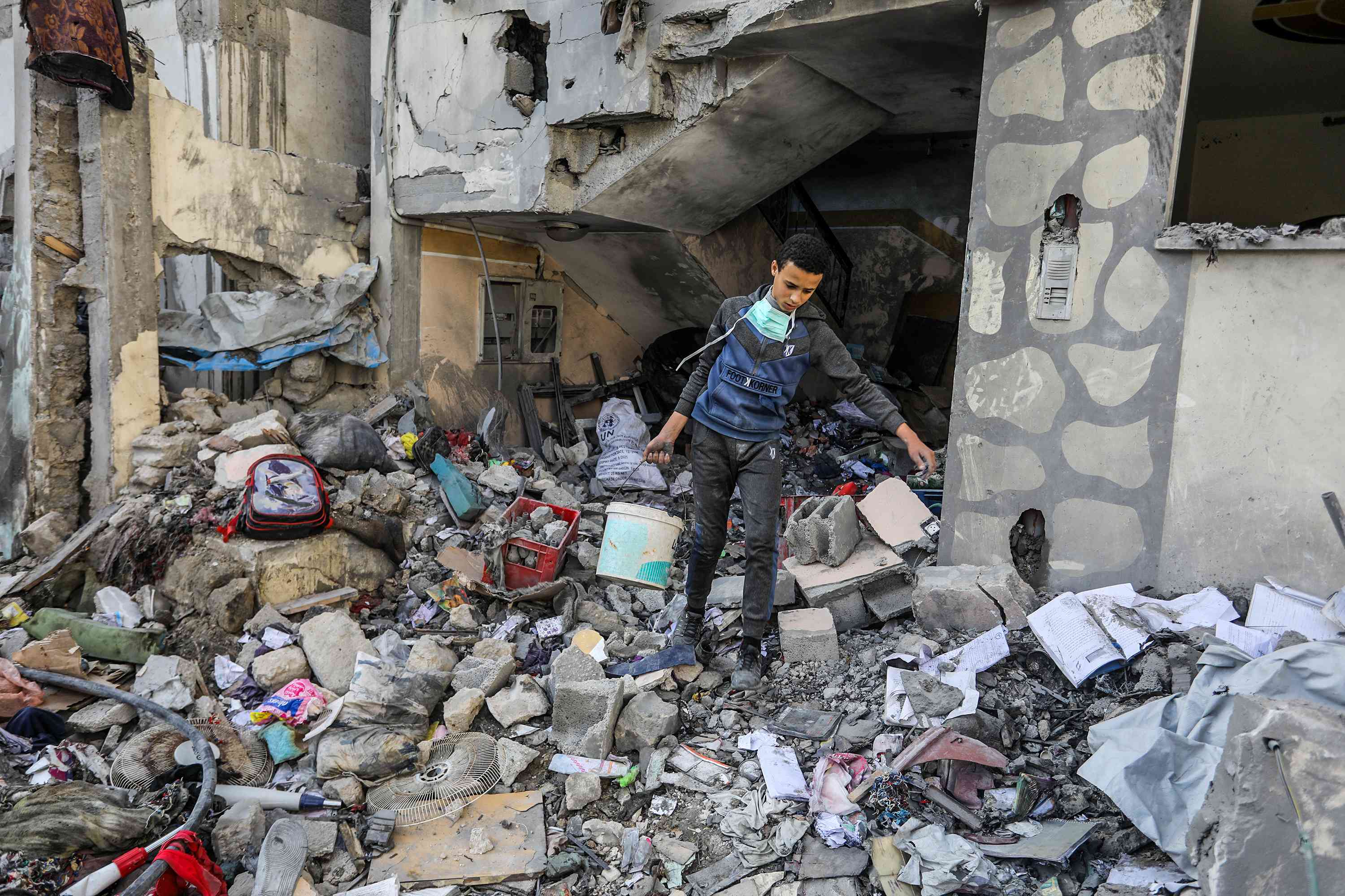 Palestinians at the scene of an Israeli airstrike in Khan Yunis, on March 18, 2025. 