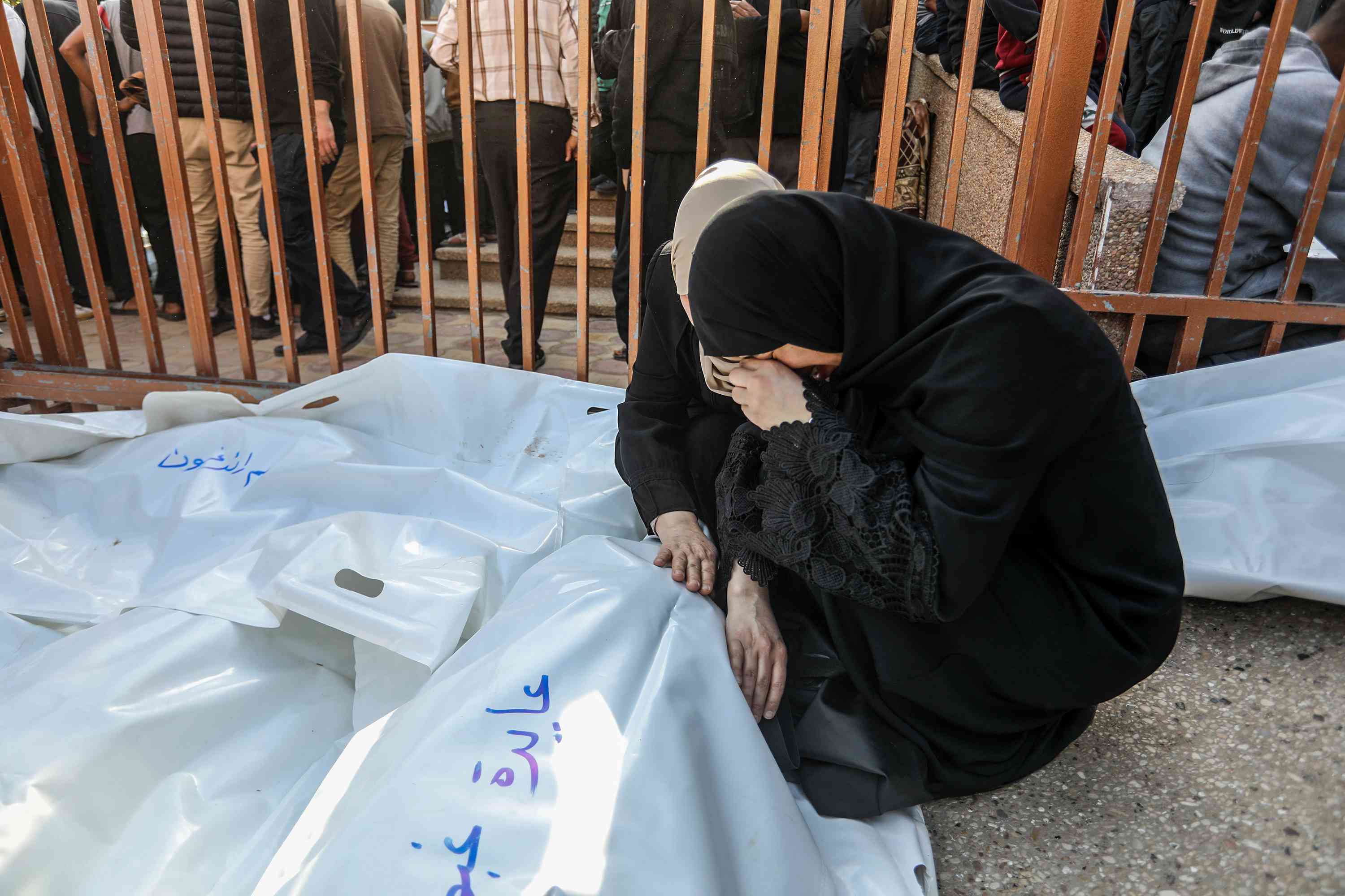 Palestinians mourn the death of Palestinians killed in an Israeli air strike outside the Nasser Hospital in Khan Yunis, in the southern Gaza Strip, March 18, 2025. 