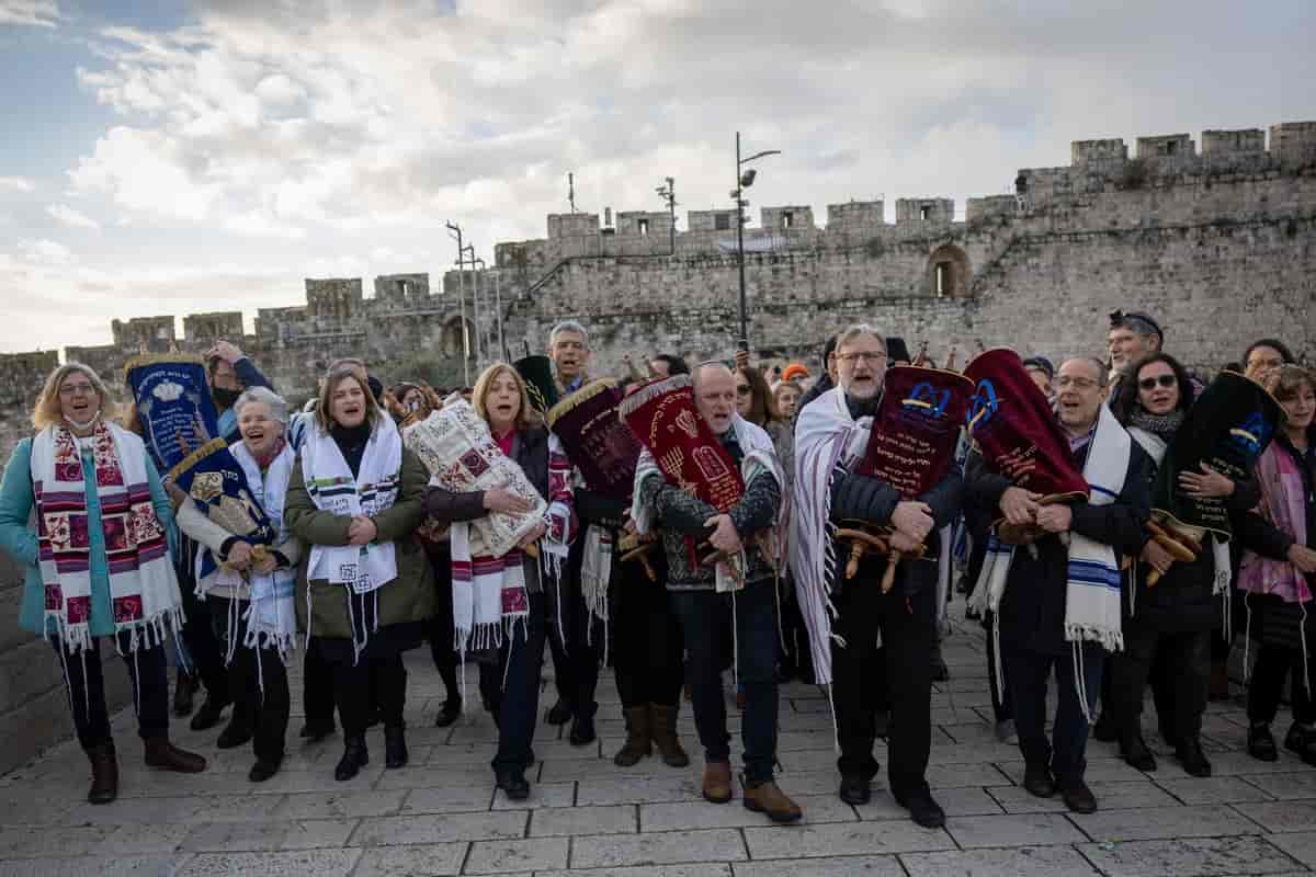 Director General of the 'World Center' movement Mr. Mauricio Balter and member of the organization's board Mr. Yizhar Hess lead a procession with Torah scrolls as part of the Women of the Wall activity on Rosh Chodesh background