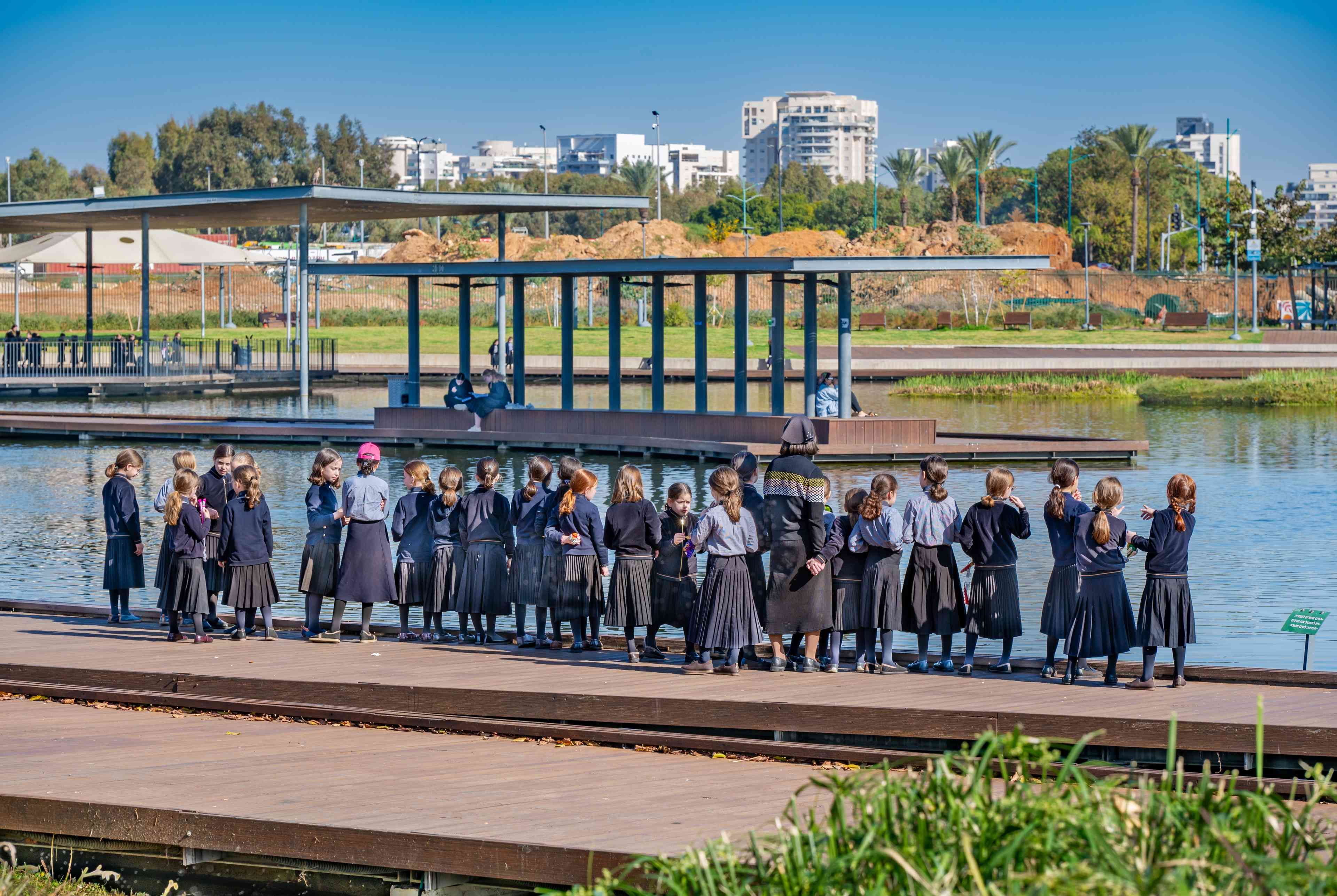 Ultra orthodox Jewish school girls at Petah Tikva park, Israel background