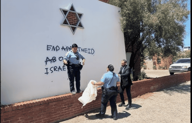 Tucson synagogue with antisemitic graffiti background