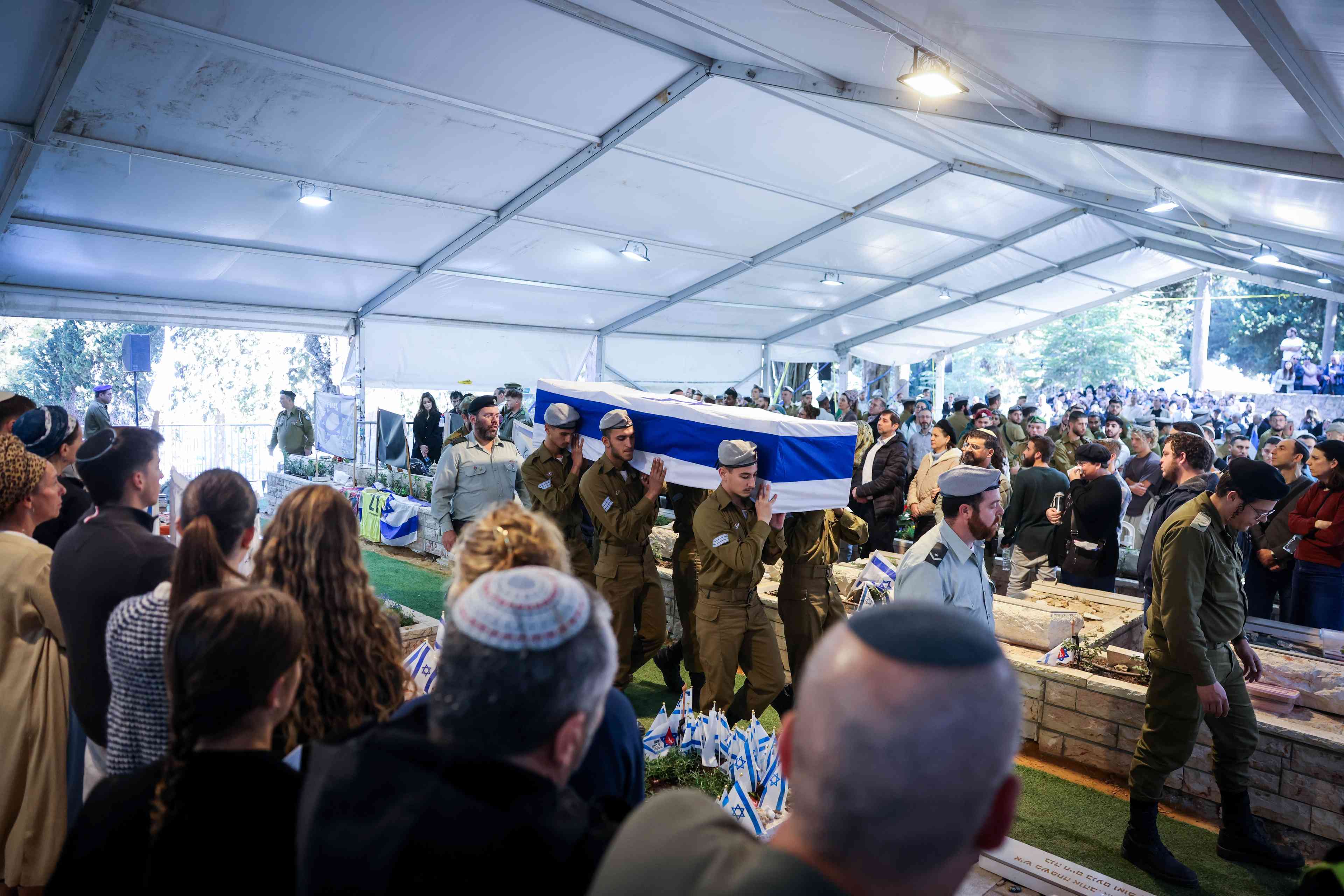 Family and friends of Israeli soldier Staff sergeant Zamir Burke attend his funeral at Mount Herzl Military Cemetery in Jerusalem on December 1, 2024. He fell in battle in the Gaza Strip. background