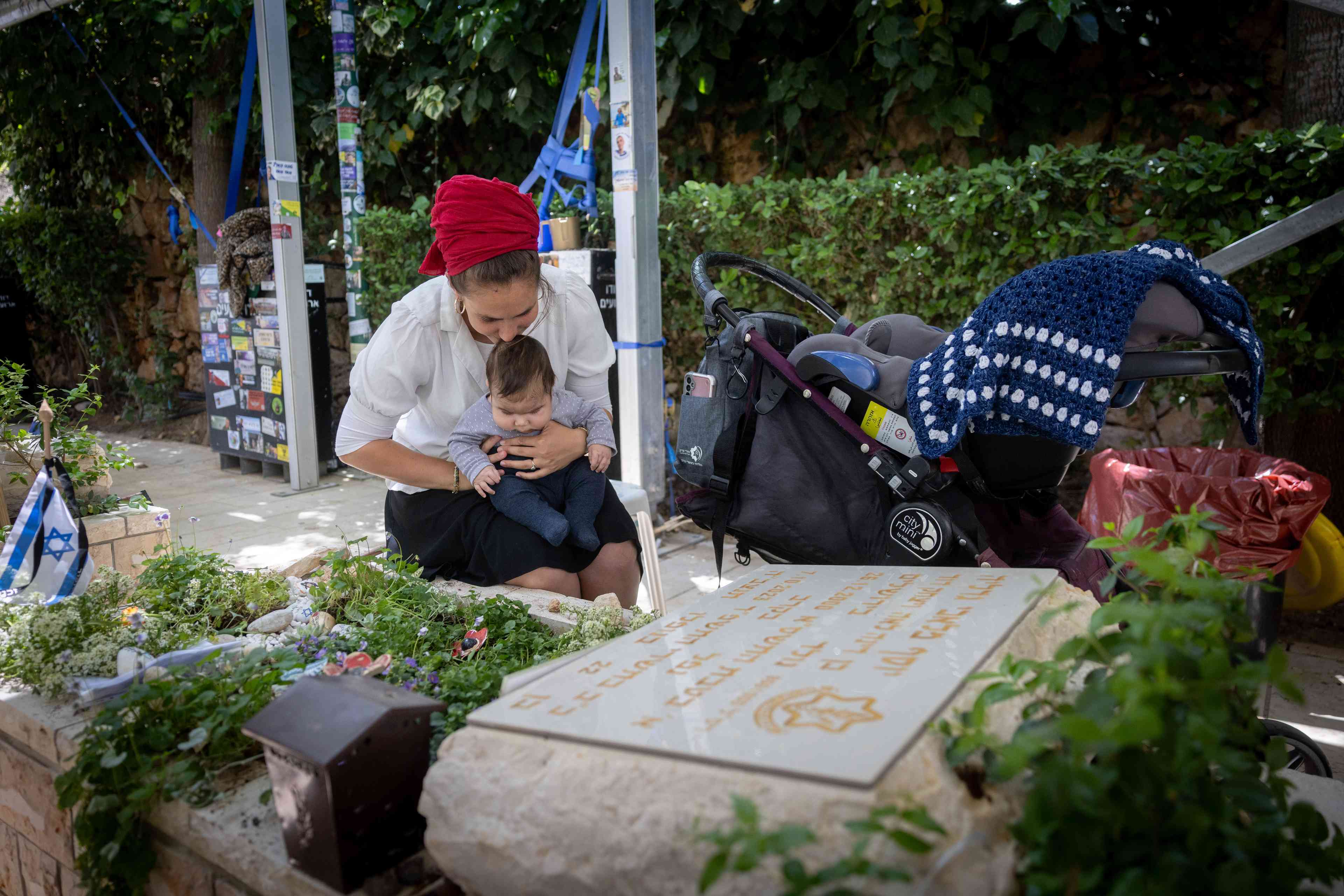 Families visit the graves of fallen Israeli soldiers a day before Memorial Day for fallen soldiers, at Mt Herzl military cemetery in Jerusalem. April 28, 2025.  background