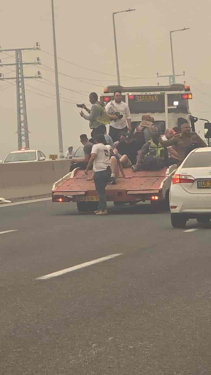 People being rescued from Road 1 on the back of lorry's to escape the fire background