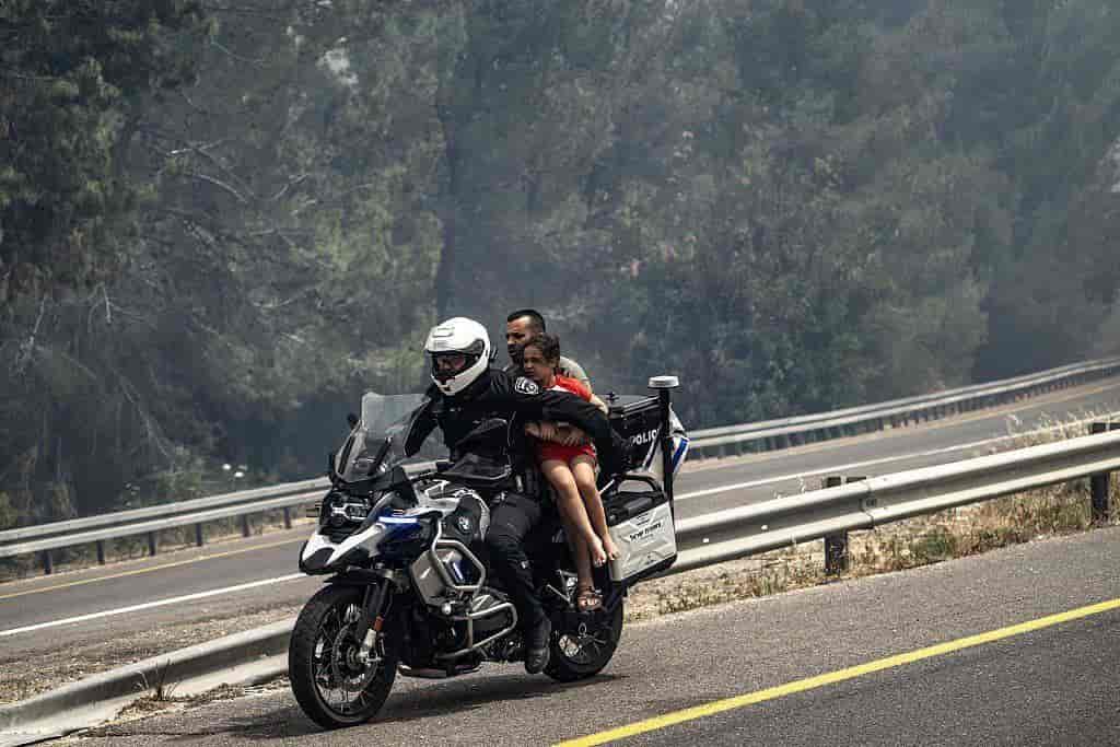 Police evacuating civilians from the fire background