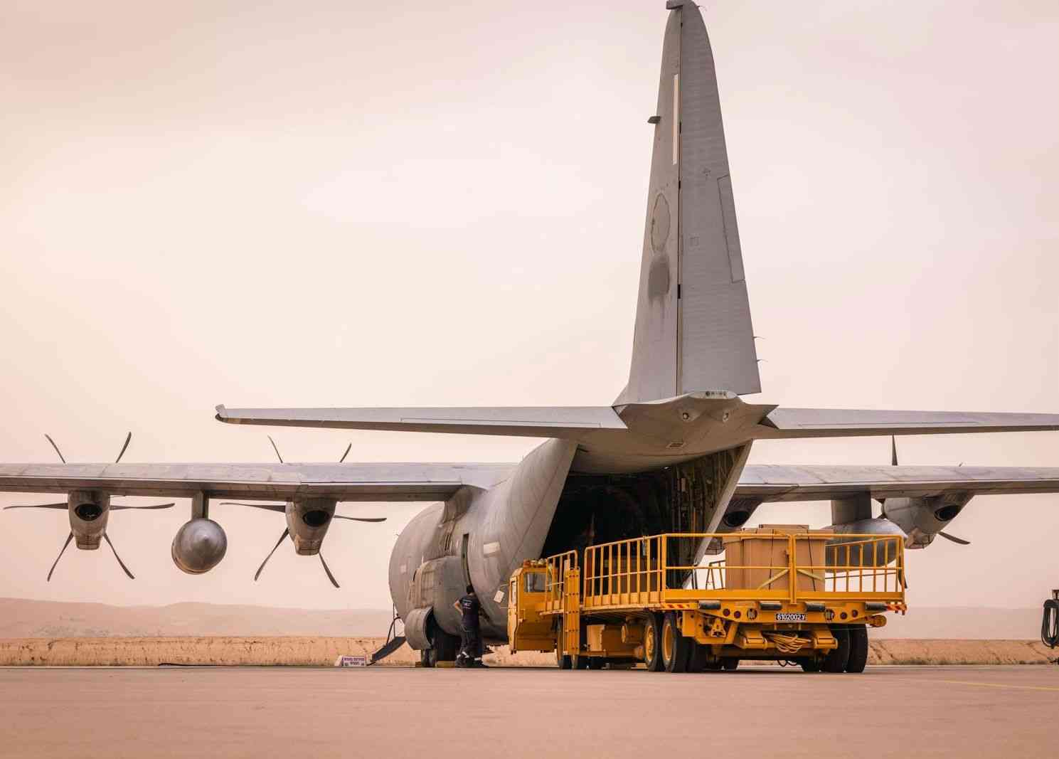 Hercules plane taking off to fight major fire. background