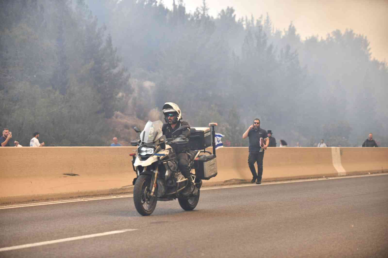 Police evacuating civilians from the fire background