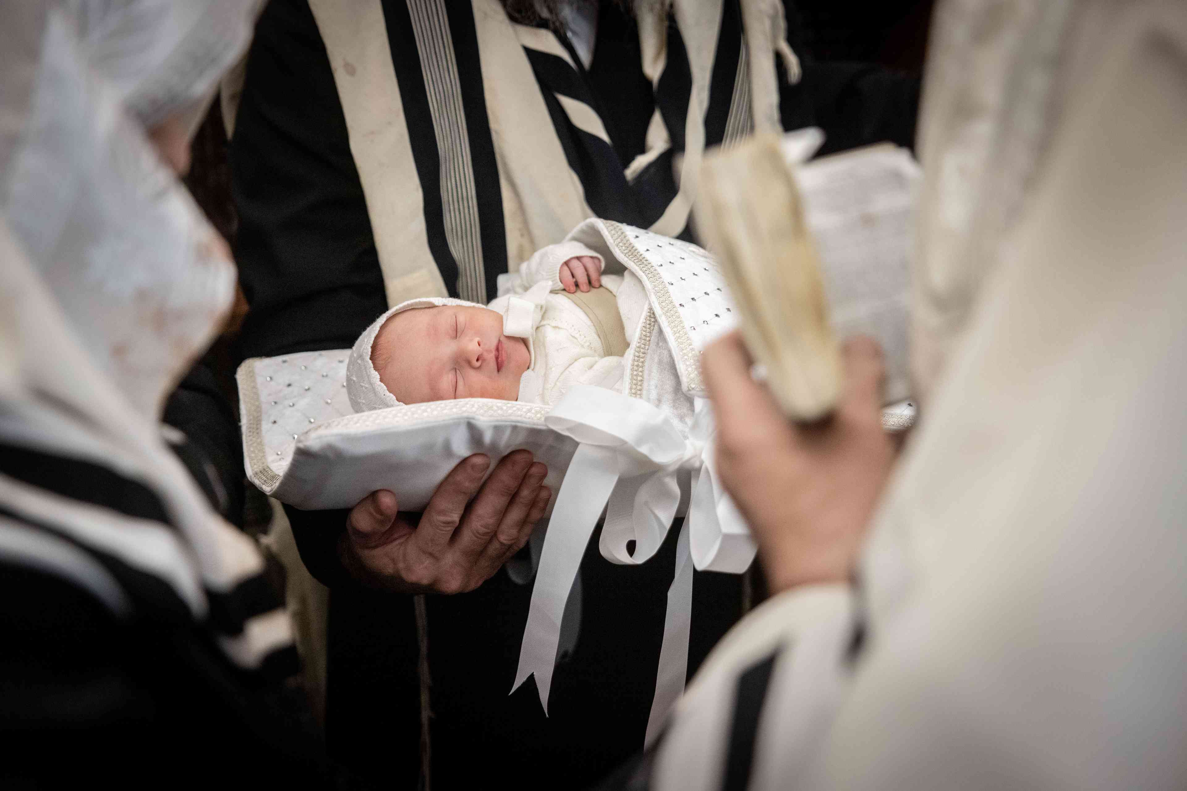 Ultra orthodox Jews perform a Brit Milah ceremony in the ultra-orthodox neighborhood of Mea Shearim in Jerusalem on December 29, 2024. background