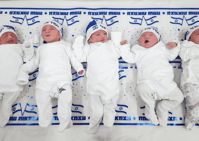 Adorably cute babies born on Independence Day background