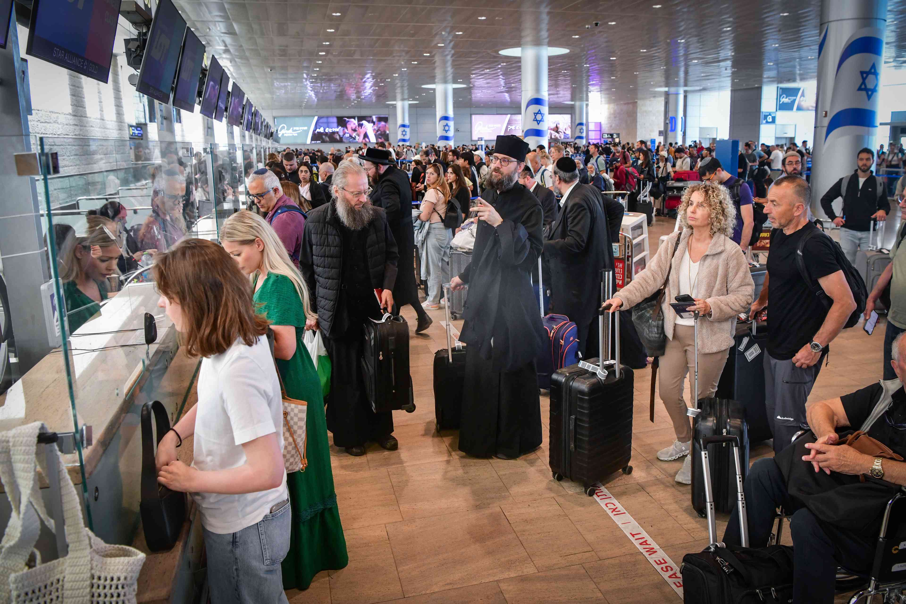 Passengers at the Ben Gurion International airport near Tel Aviv on May 4, 2025. background