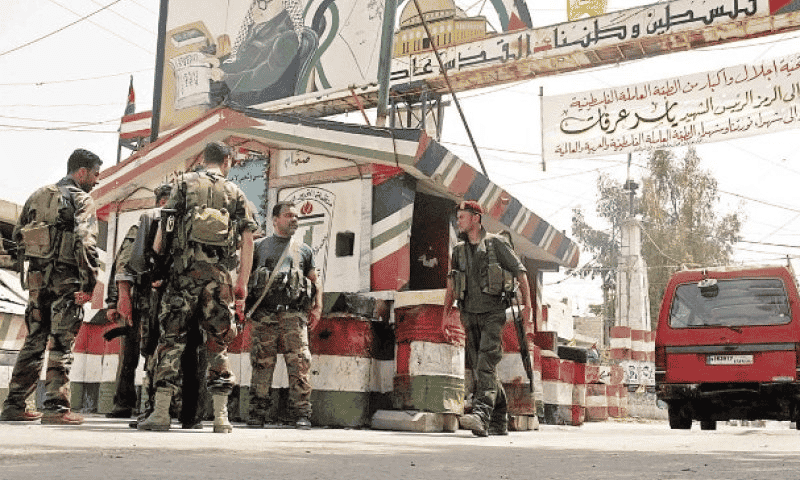 Armed Palestinians in Lebanon camp background