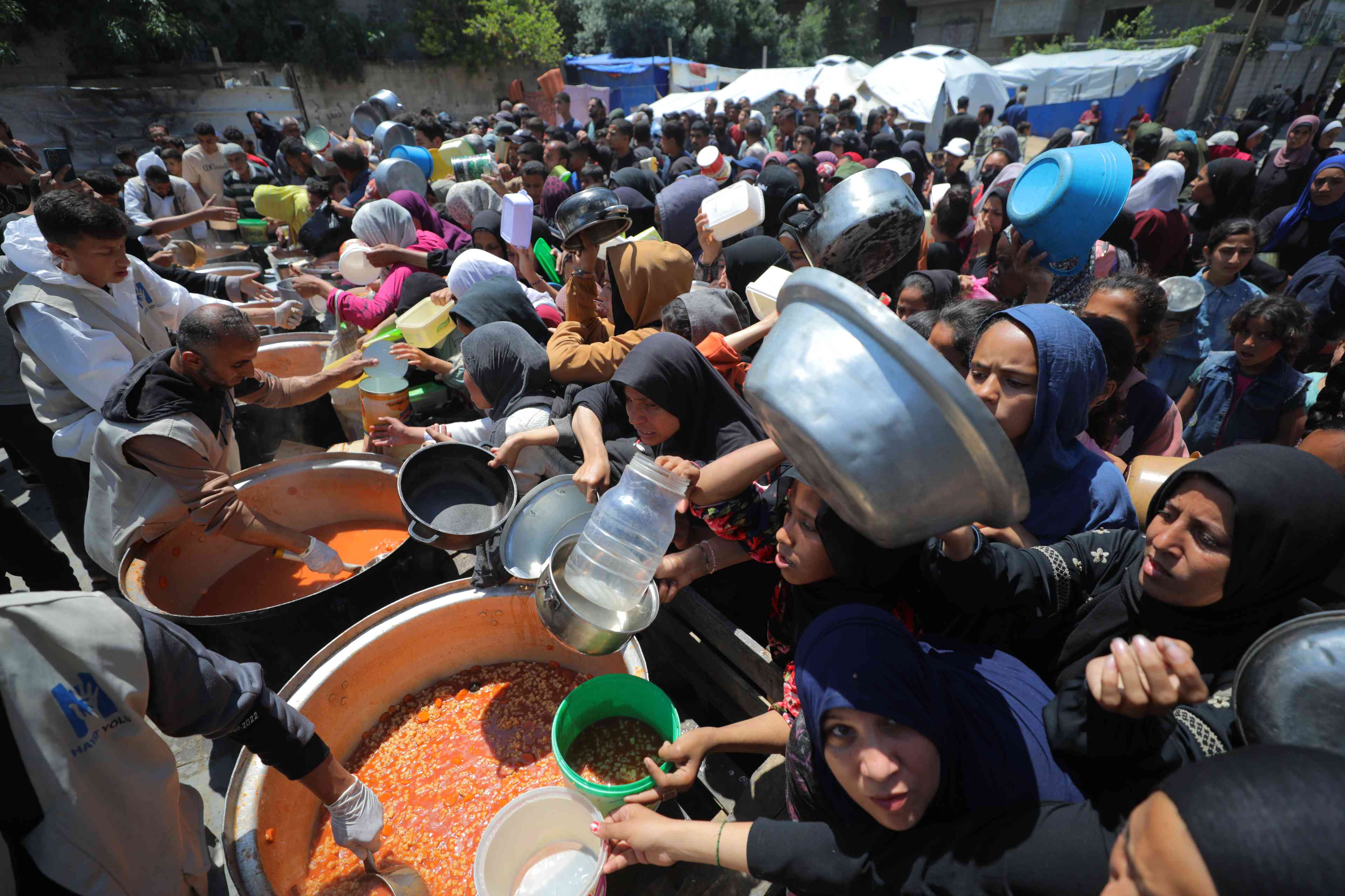 Distributing humanitarian aid to Gazans. background