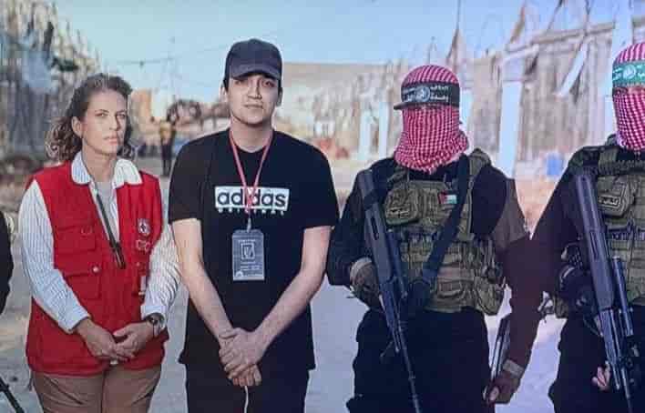 Hostage Edan Alexander being handed over to the red cross by Hamas background