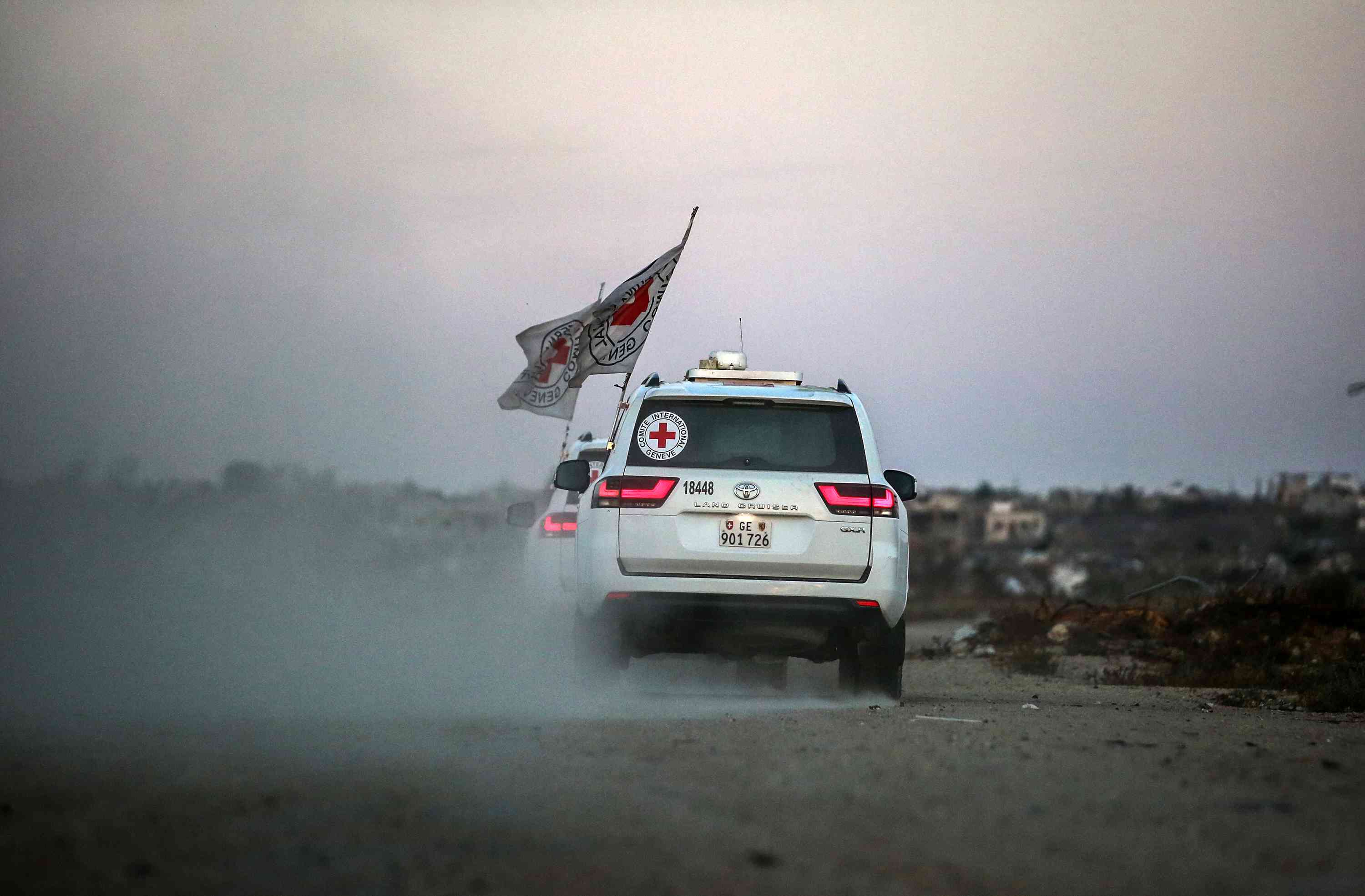 International Red Cross (ICRC) vehicles drive in Deir el-Balah, as they transports US-Israeli hostage Edan Alexander after being released from Hamas captivity on May 12, 2025. background