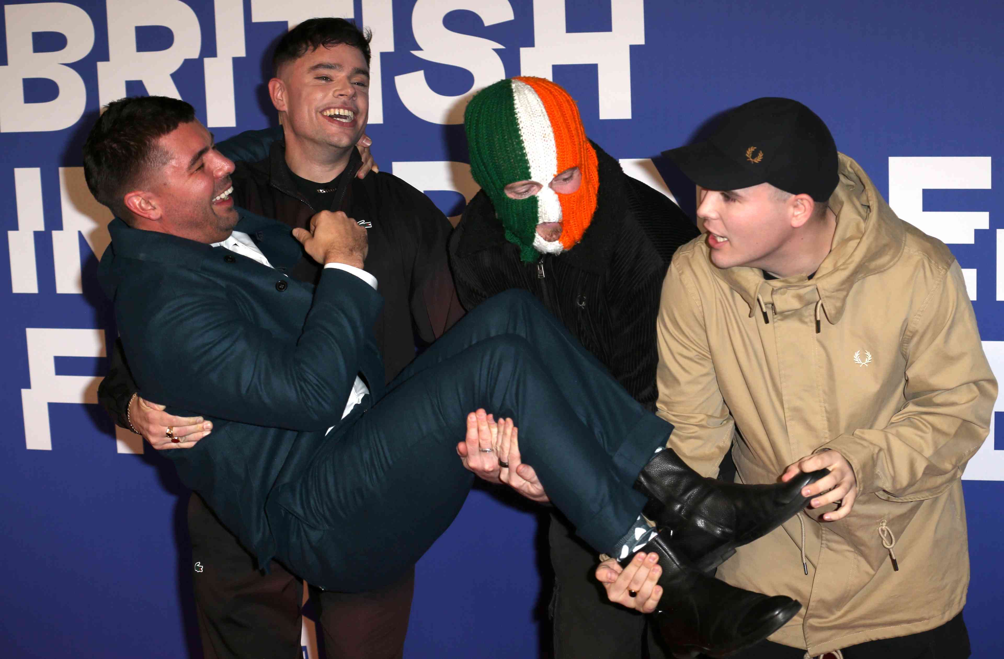 Móglaí Bap, Rich Peppiatt, Mo Chara and DJ Provaí attend the 27th British Independent Film Awards at the Roundhouse in Camden, London, England. background