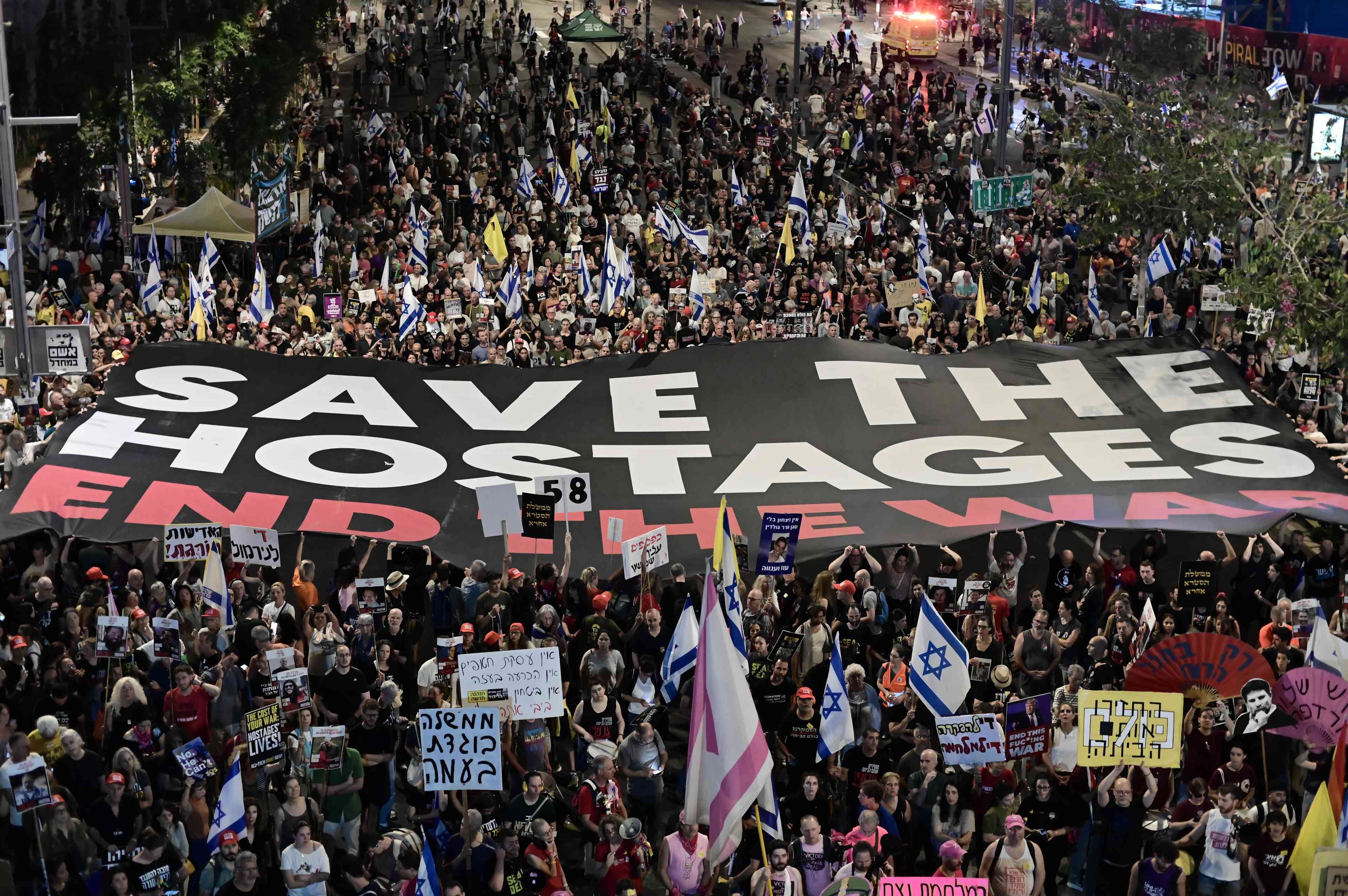 Demonstrators protest against the Israeli government and for the release of Israelis held hostage in the Gaza Strip outside Hakirya Base in Tel Aviv, May 24, 2025. background