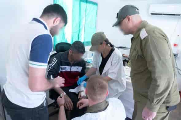 IDF treating civilians in Syria background