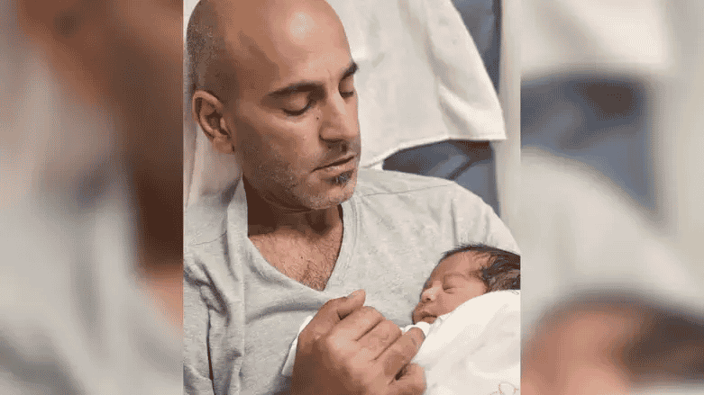 Itai and his newborn son Bar Shavit background