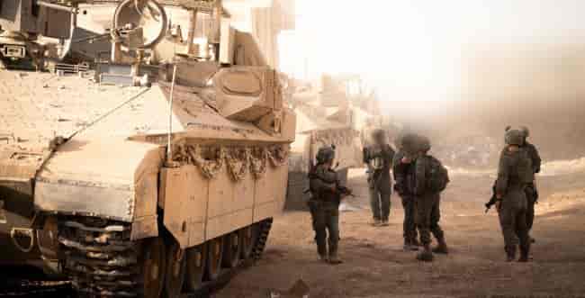 IDF soldiers in Gaza background