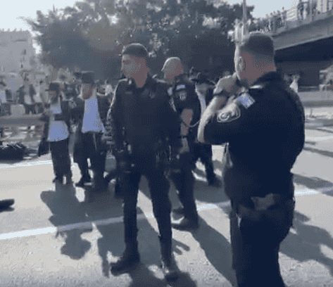 Police overseeing protest on Road 4. background