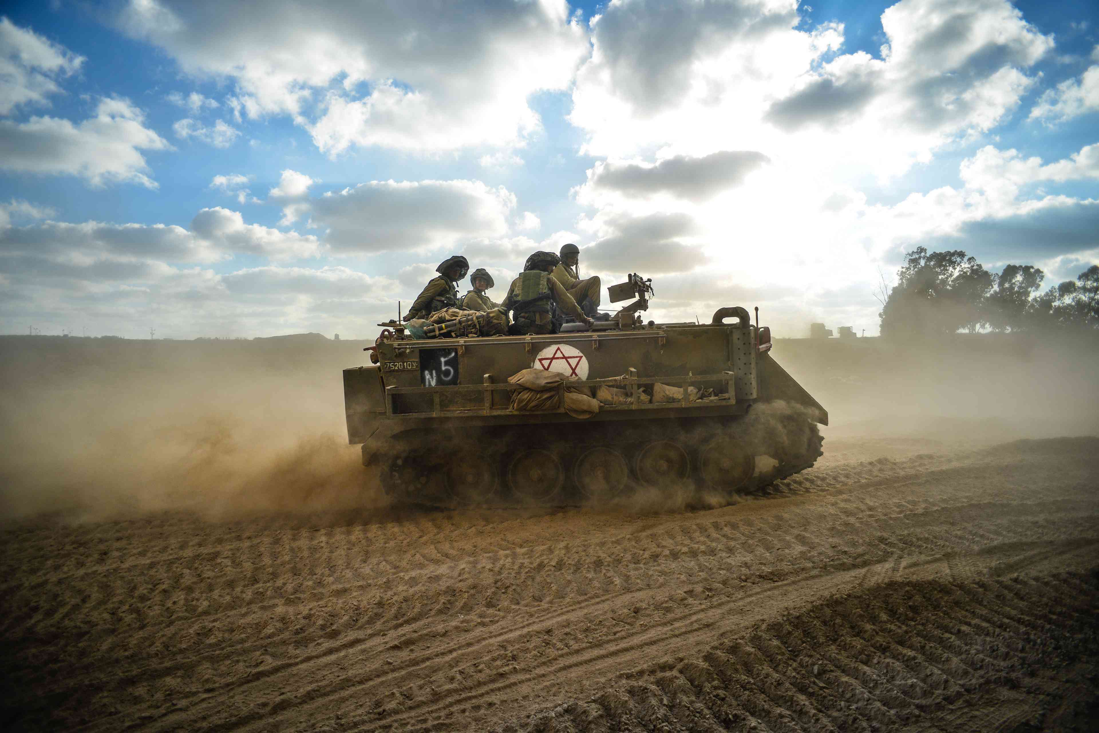 Israeli armored personal carrier on their way into Gaza Strip during Israel -Hamas fighting S background