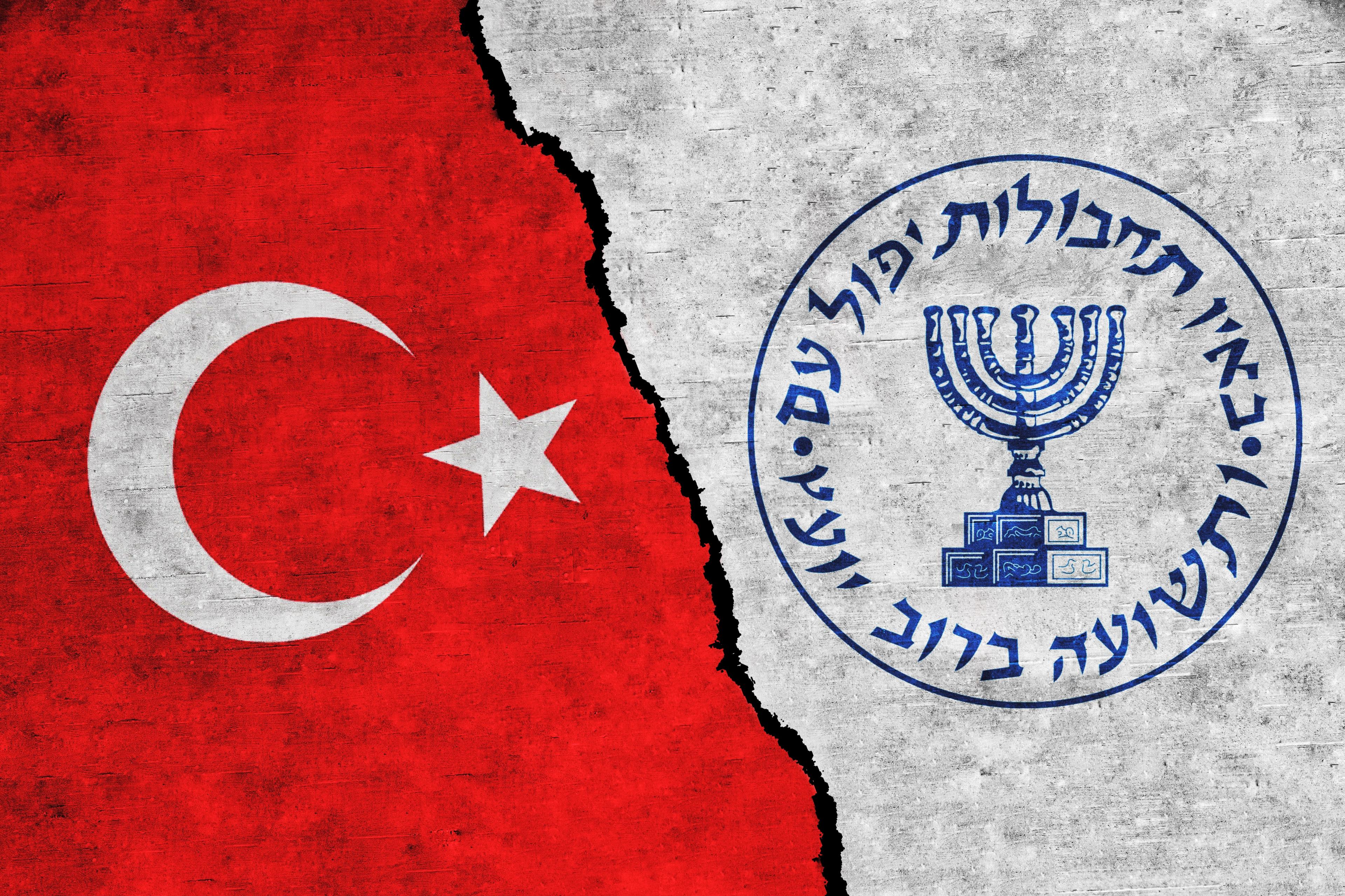 Illustration. Turkey and Mossad painted flags on a wall with a crack.