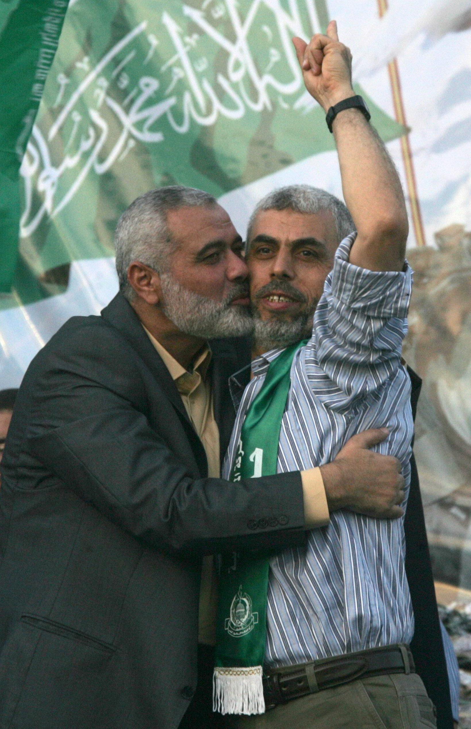 Hamas leader Ismail Haniya kisses freed Palestinian prisoner Yehiye Sinwar, a founder of Hamas' military wing, wave as Hamas supporters celebrate the release of hundreds of prisoners in the Shalit deal. Hamas leader Ismail Haniya kisses freed Palestinian prisoner Yehiye Sinwar, a founder of Hamas' military wing, wave as Hamas supporters celebrate the release of hundreds of prisoners in the Shalit deal.