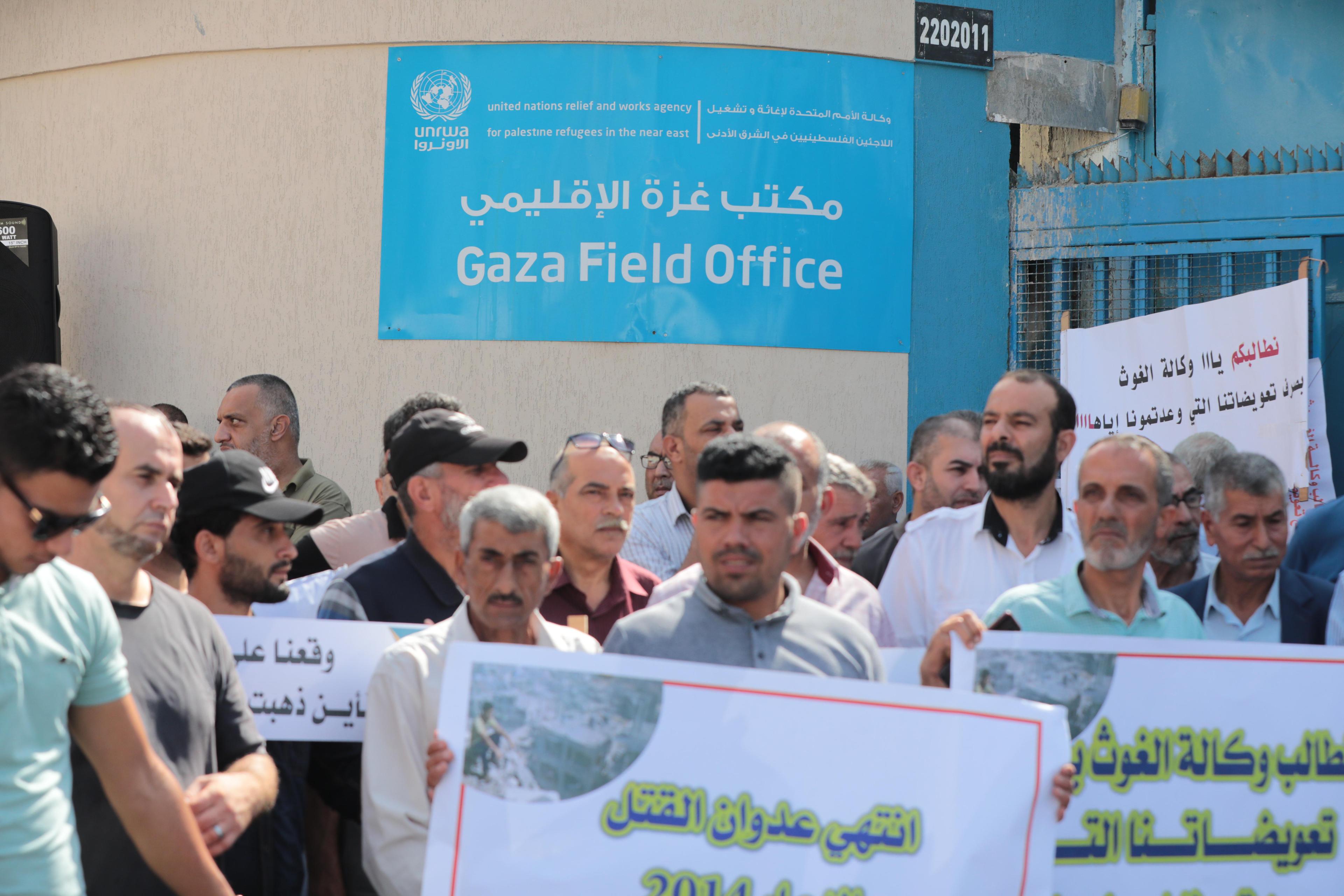 Palestinians protest demanding compensation for damaged homes in the 2014 war, outside the headquarters of "UNRWA", in Gaza City, on September 5, 2022. Palestinians protest demanding compensation for damaged homes in the 2014 war, outside the headquarters of "UNRWA", in Gaza City, on September 5, 2022.