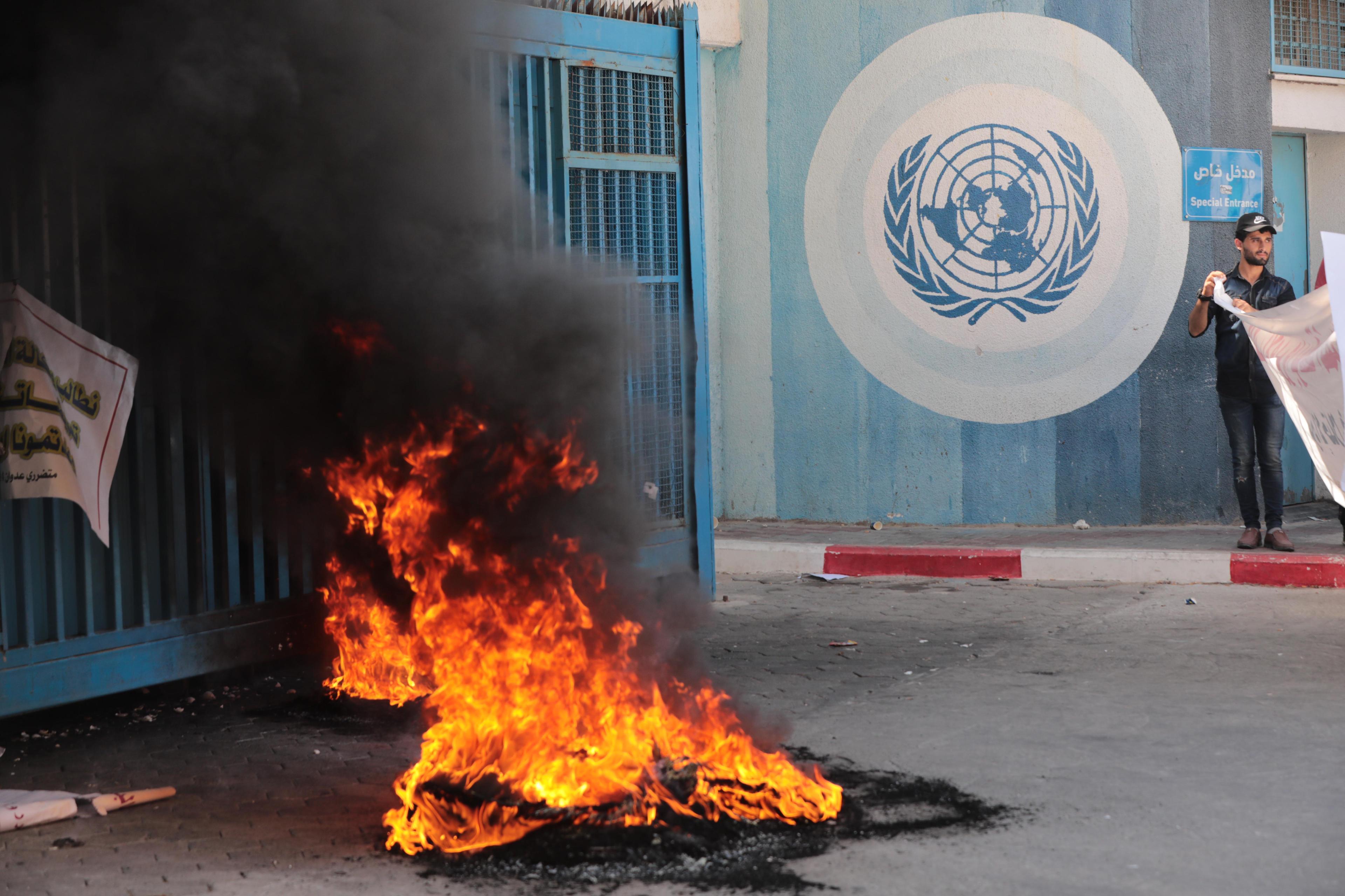 Palestinians protest demanding compensation for damaged homes in the 2014 war, outside the headquarters of "UNRWA", in Gaza City, on September 5, 2022.