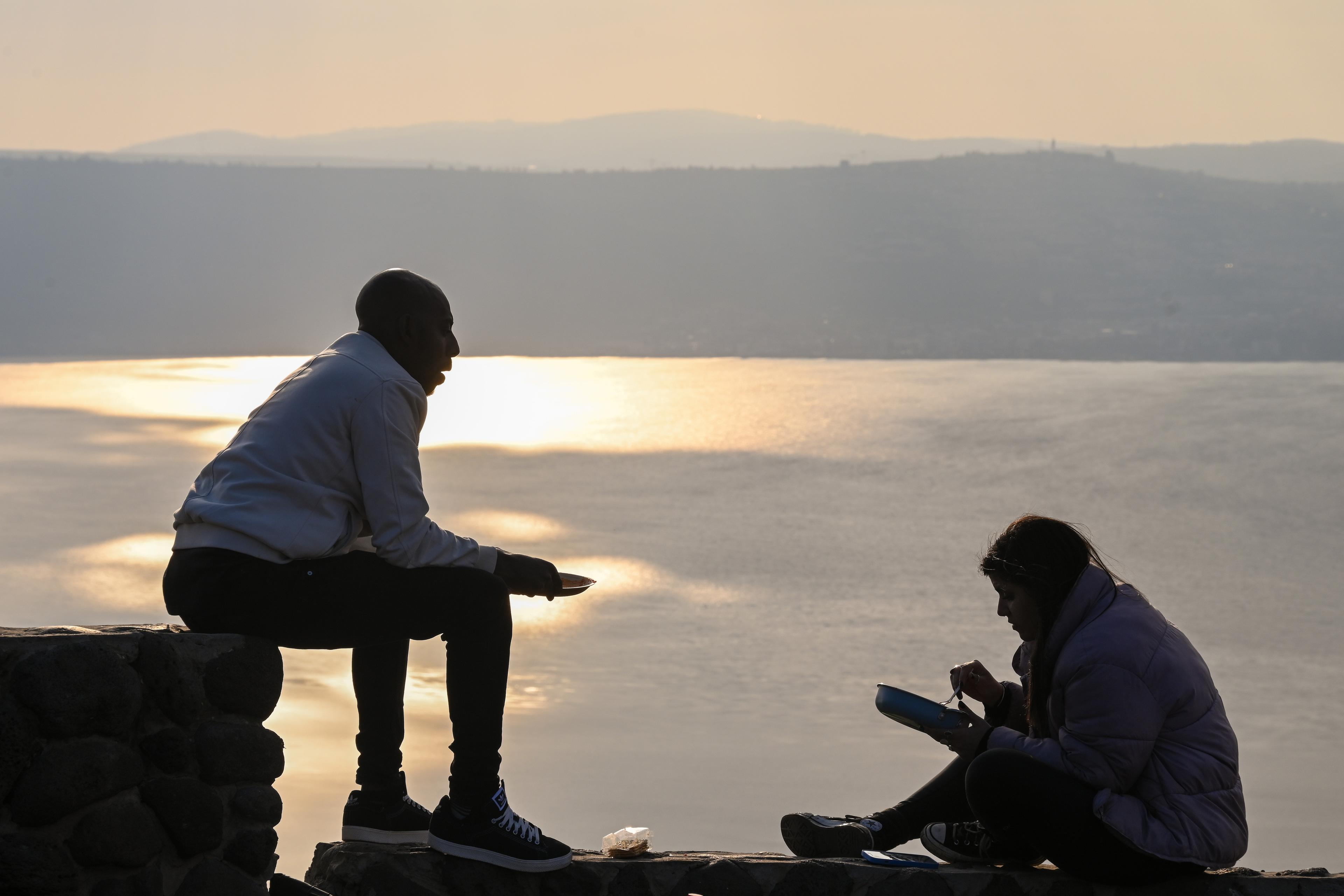 Israelis enjoying the Sea of Galilee at sunset. Israelis enjoying the Sea of Galilee at sunset.
