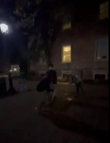 Students removing hostage names written on the ground.