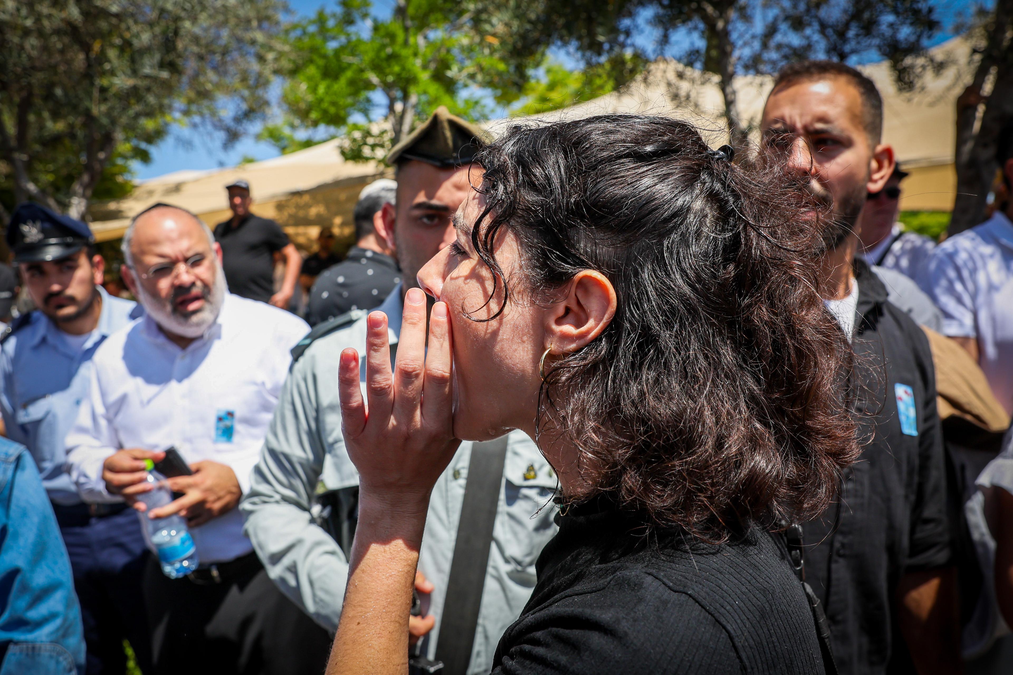 People react during a speech of Minister of National Security Itamar Ben Gvir at an official Memorial Day ceremony which commemorates the fallen Israeli soldiers and victims of terror in Ashdod Military Cemetery on May 13, 2024. 