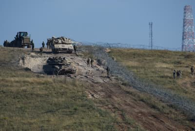 Israeli soldiers guard near an Israeli Merkava tank near the barbed wire fence in the Lebanon-Israel 'Blue Line', near Misgav, northern Israel Israeli soldiers guard near an Israeli Merkava tank near the barbed wire fence in the Lebanon-Israel 'Blue Line', near Misgav, northern Israel