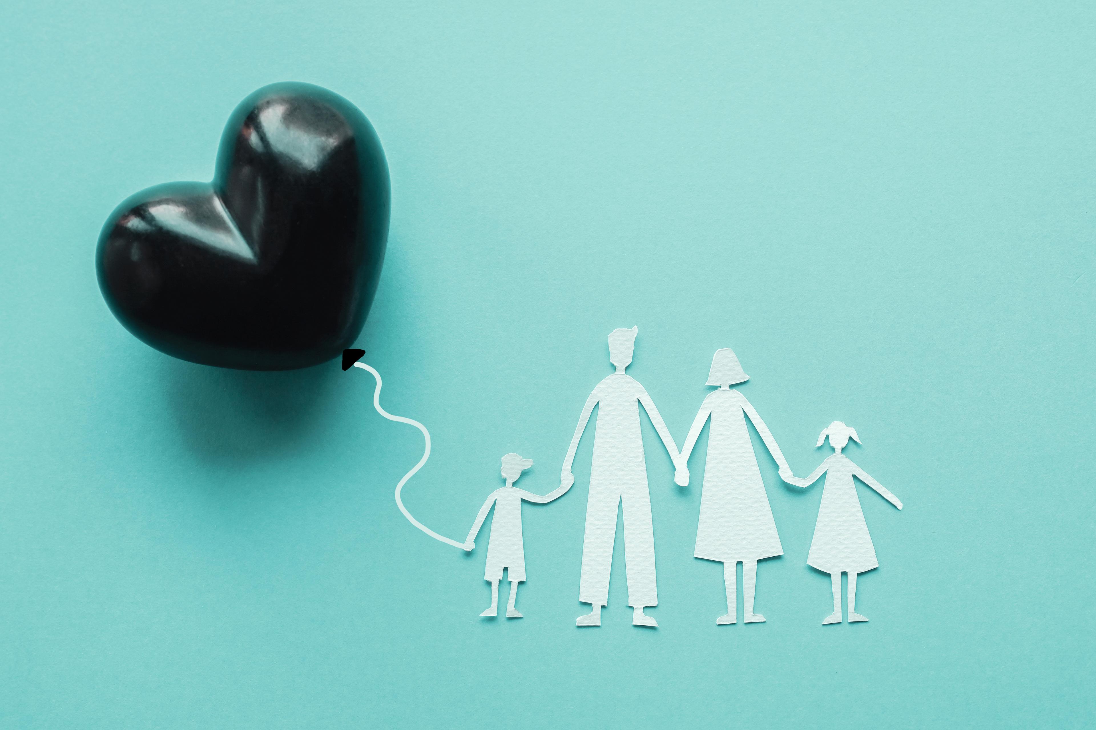Family paper cut out and black heart balloon Family paper cut out and black heart balloon