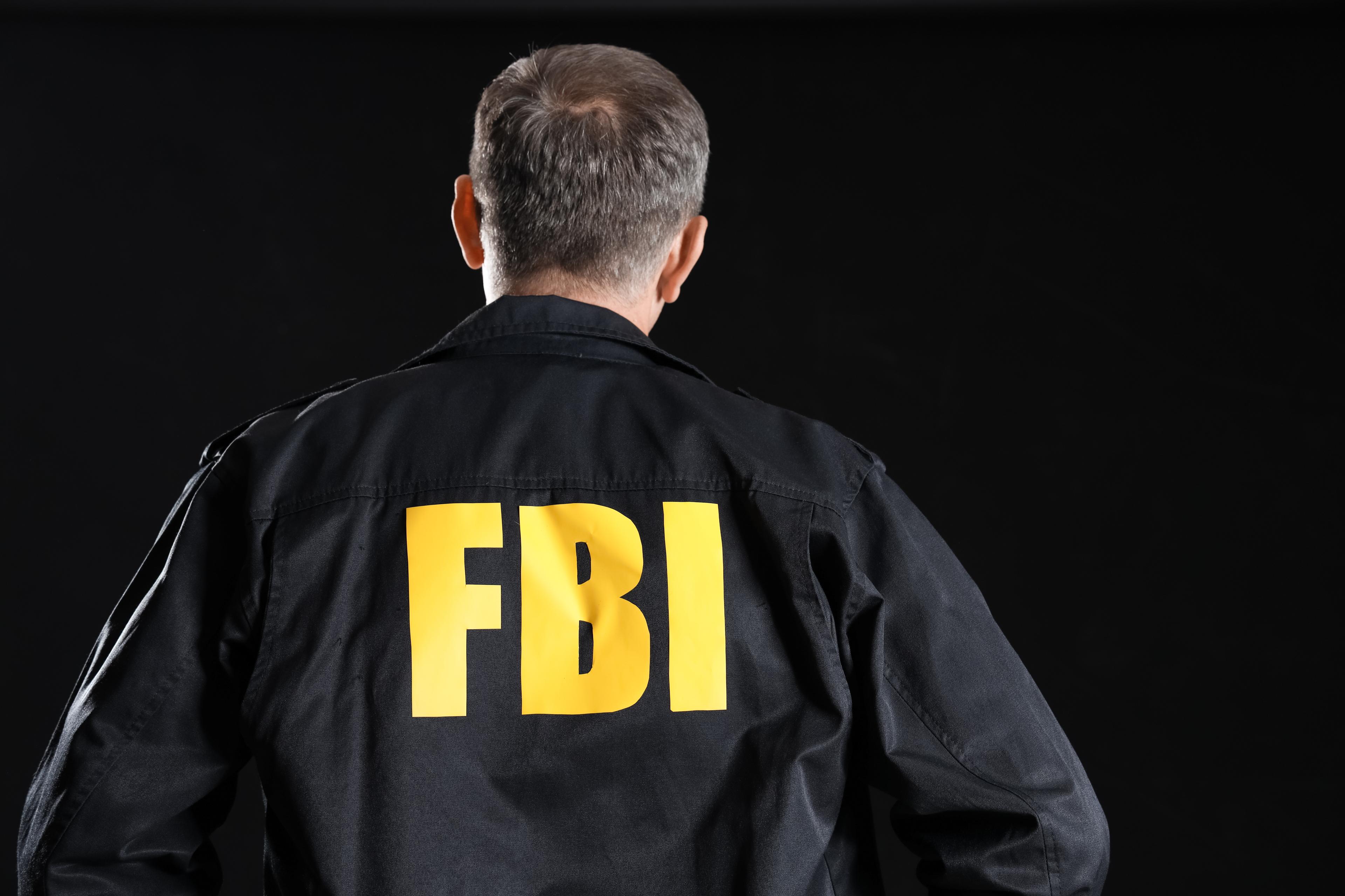 Mature FBI agent on black background
